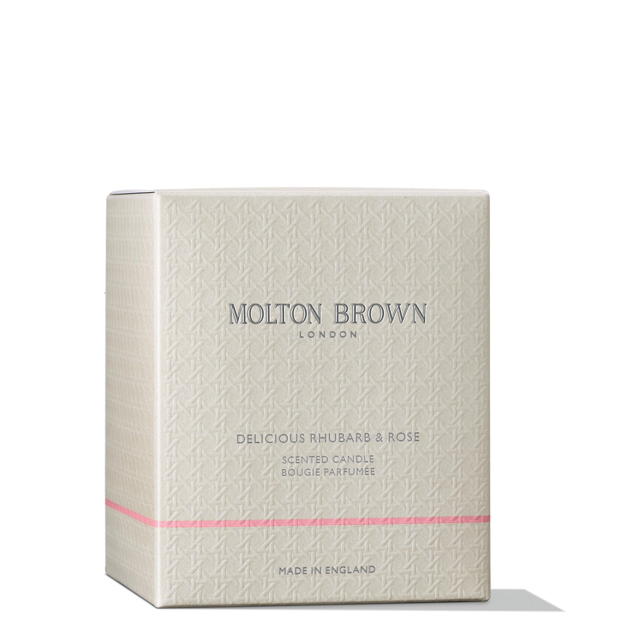 A beige box with a subtle texture and thin pink stripe, labeled MoltonBrown Nederlands. It reads Delicious Rhubarb & Rose Signature Kaars 190g, also as Rabarber & Roos geurkaars. Marked Made in England.