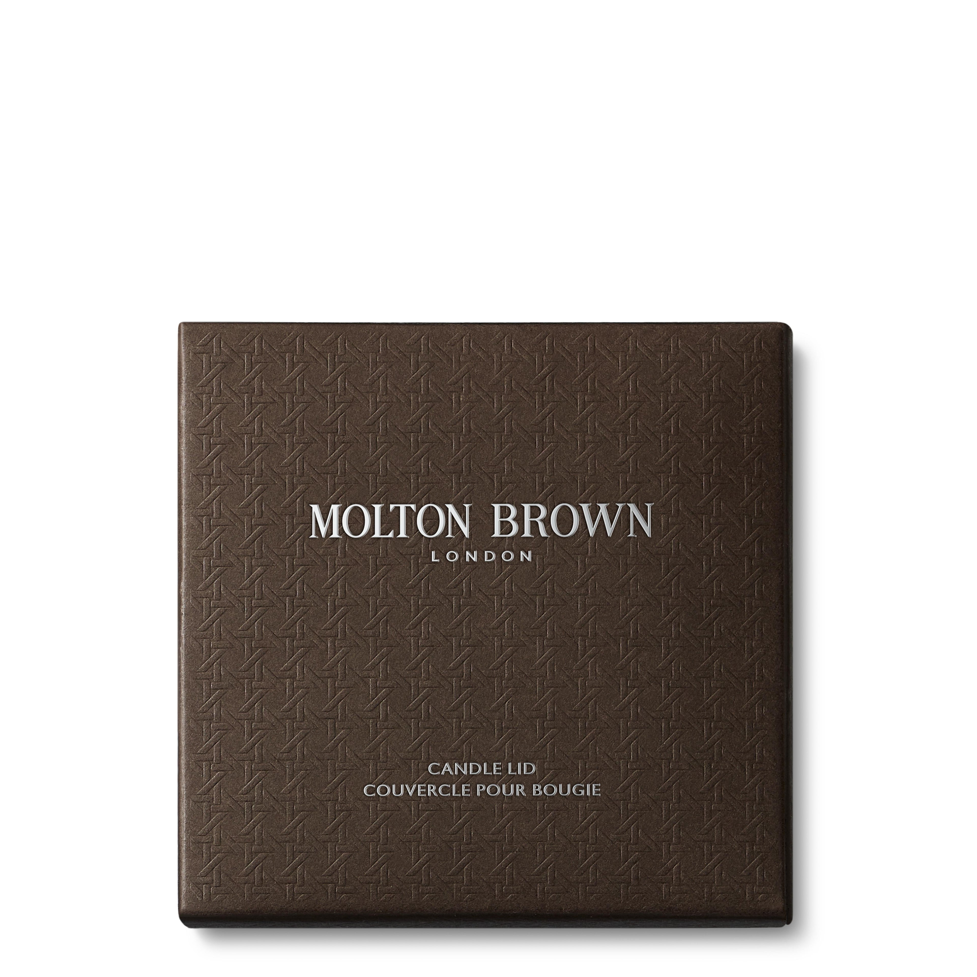 A stylish, textured brown Signature Kaars Lid 98g box from MoltonBrown Nederlands with zilveren logo, ideaal om je kaars te beschermen en het geur te behouden met de elegante kaars deksel.