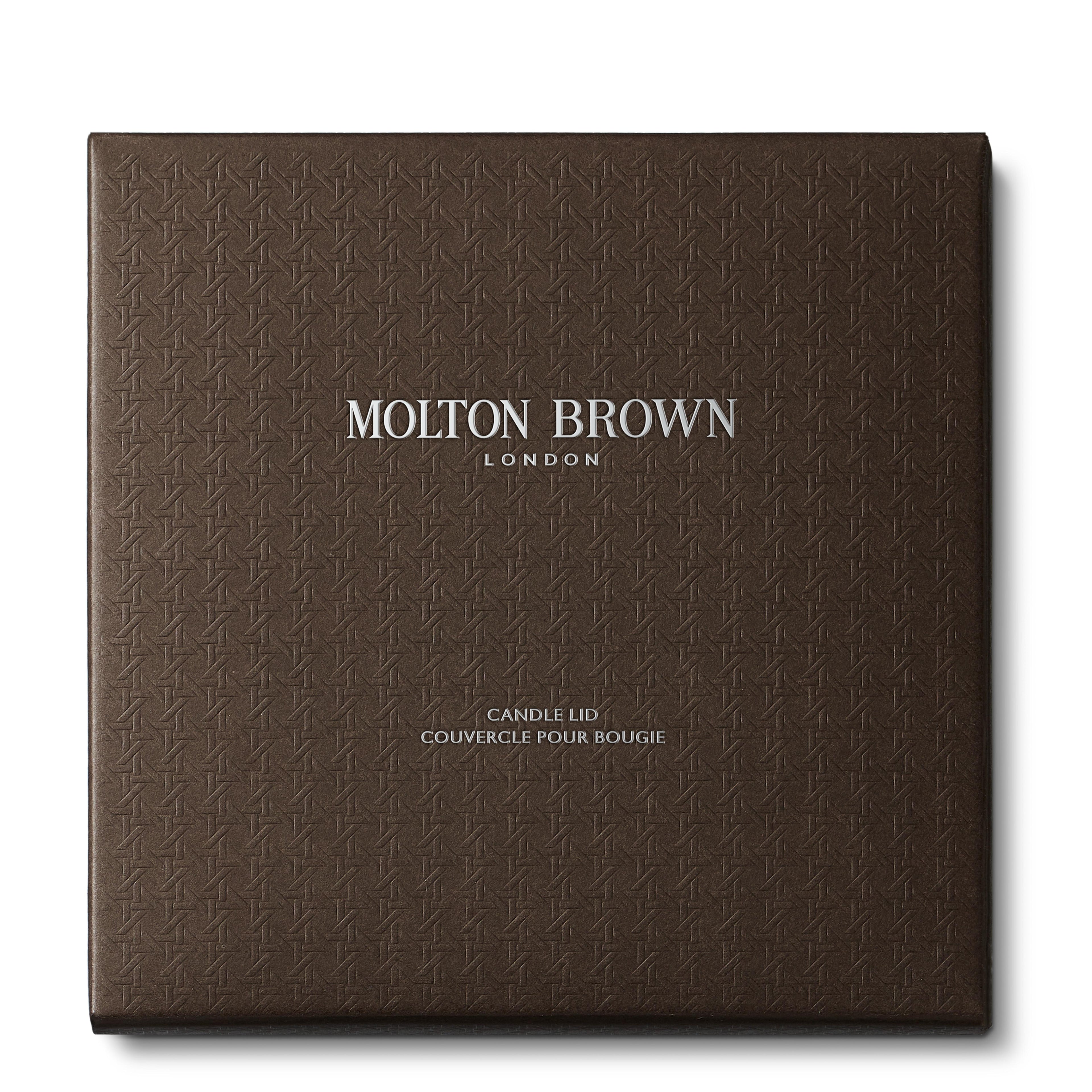 A square, textured dark brown box with MoltonBrown Nederlands in silver at the center and Luxury Kaars Lid 154g below—a perfect kaarsaccessoire for any space.
