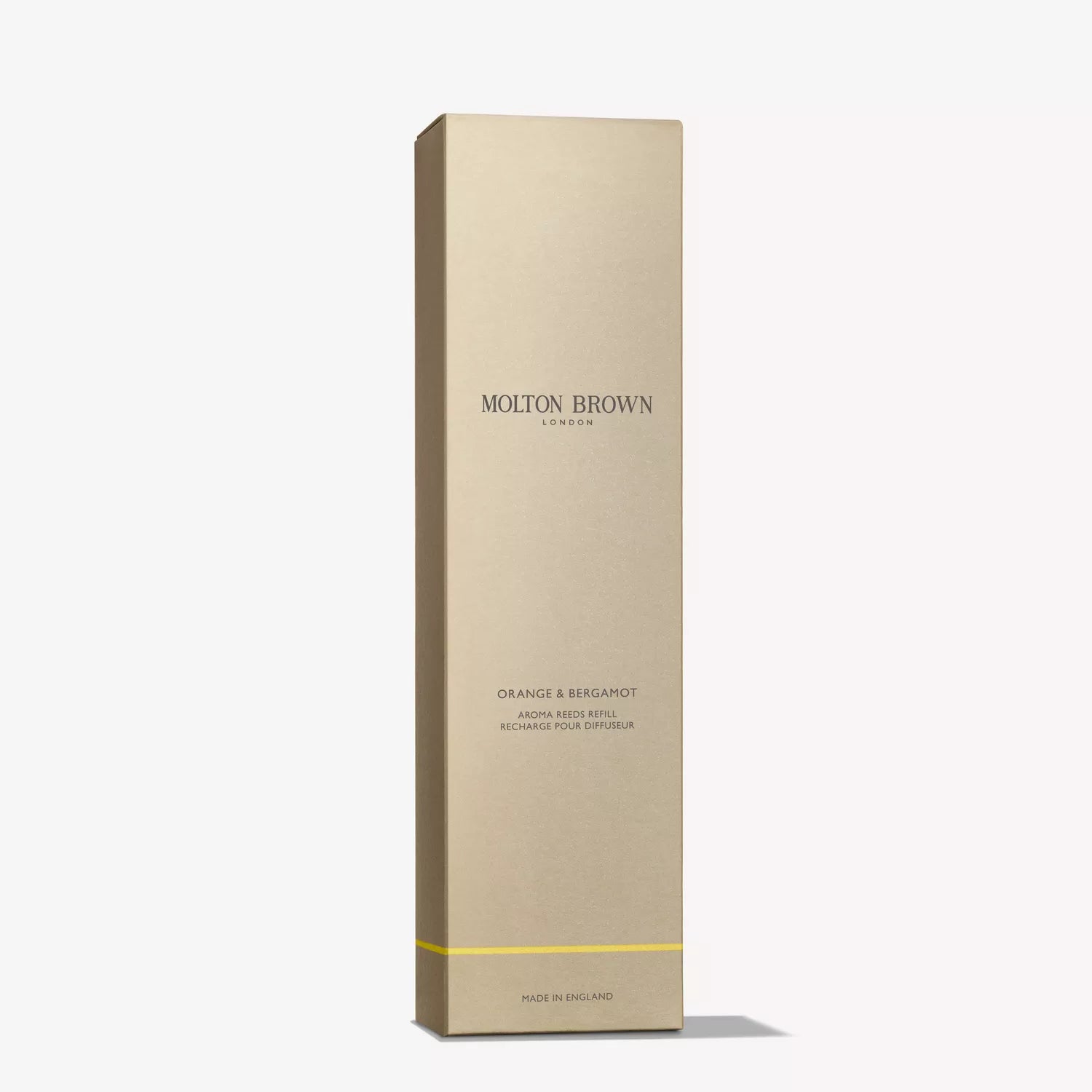 Tall, rectangular beige box with Molton Brown Nederlands branding in gold letters. The Fiery Pink Pepper Perfumed Soap 150g pairs perfectly with their aroma reeds refill. A thin yellow line accents the bottom.