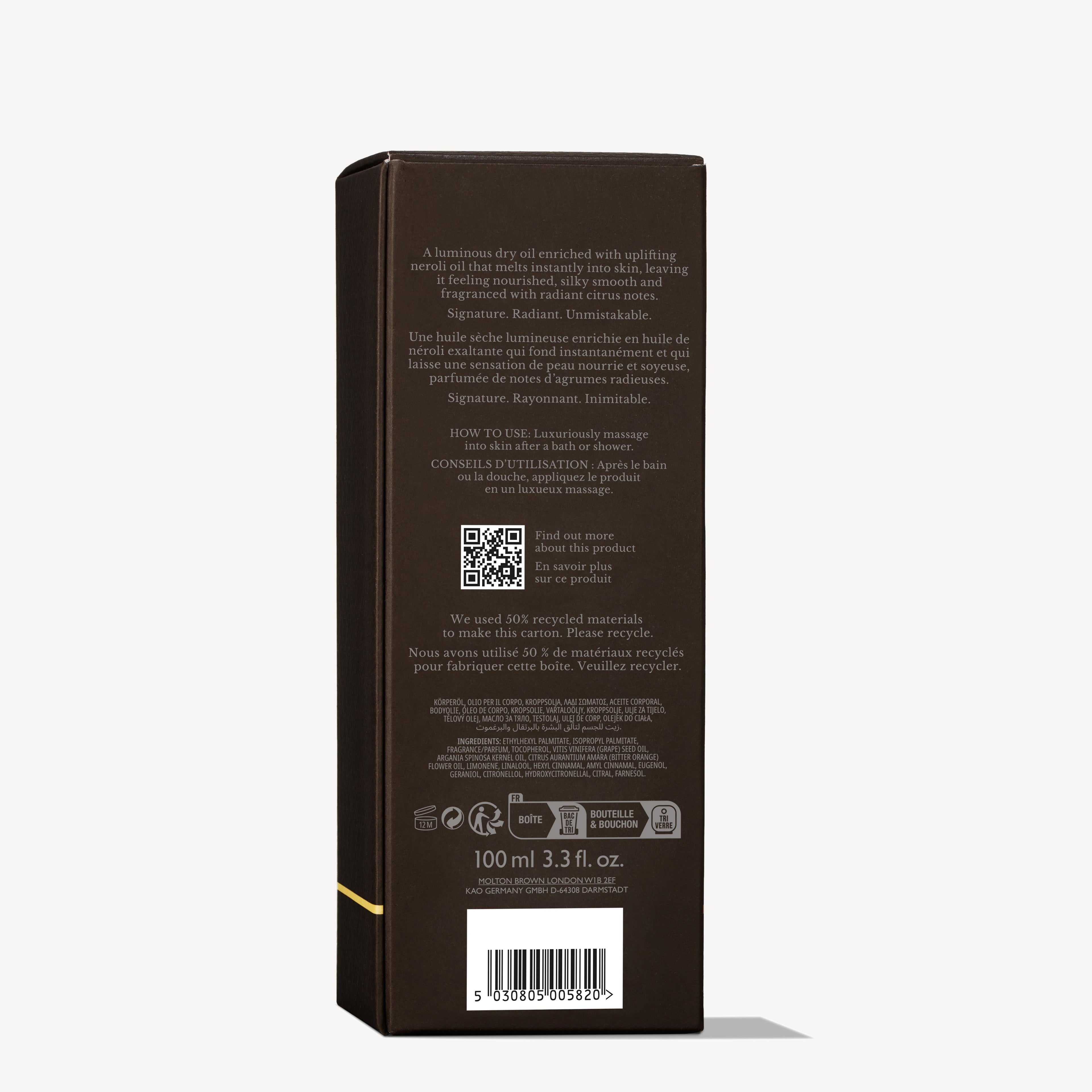 A rectangular dark brown MoltonBrown Nederlands box for Orange & Bergamot Radiant Lichaamsolie 100ml stands upright, featuring English and French text on use and recycling, a QR code, barcode, gold accents, and size: 100 ml (3.3 fl. oz.).