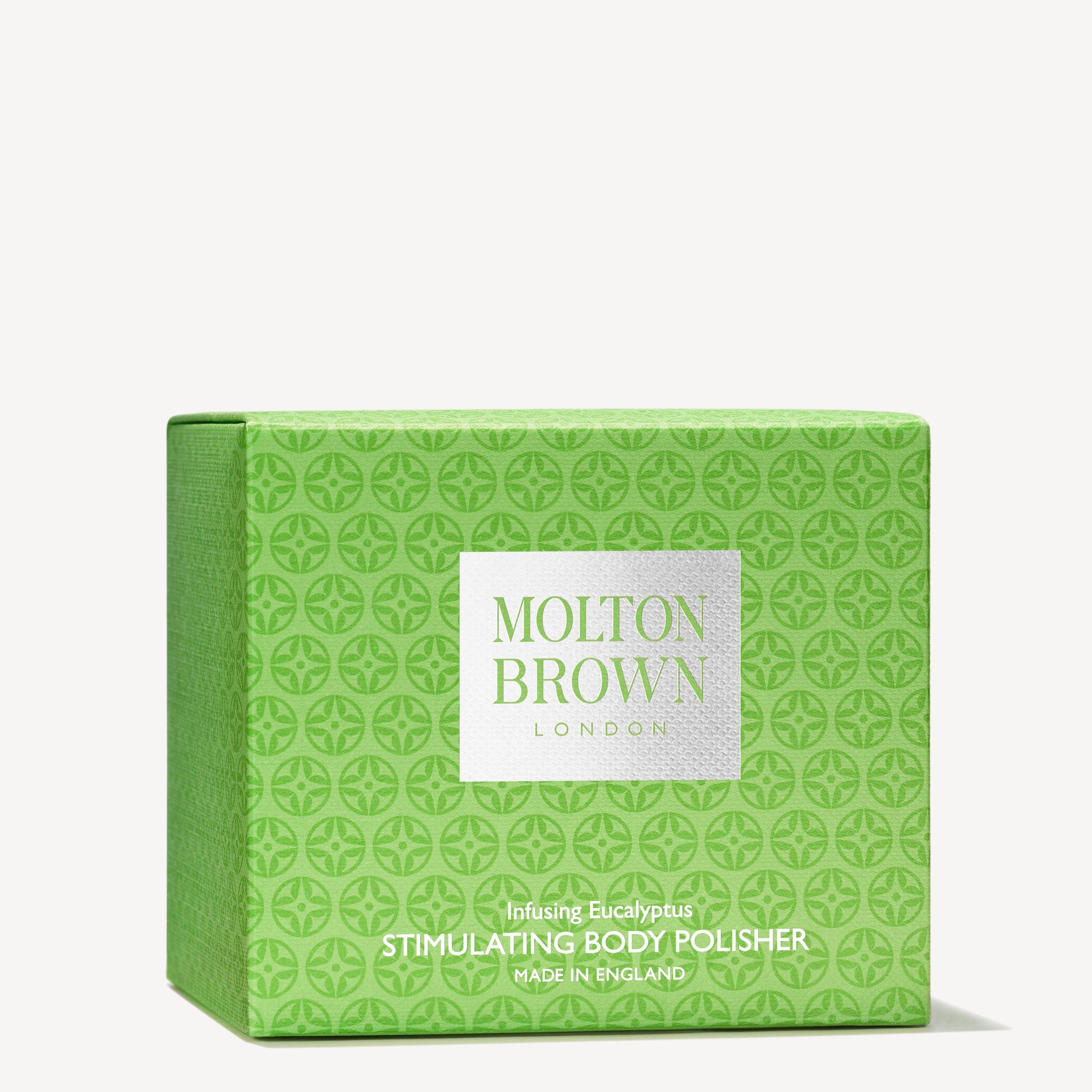 A green box with a circle pattern from MoltonBrown Nederlands holds the Infusing Eucalyptus Stimulating Body Polisher 275g. Made in England, it features jojoba korrels and a houtig-citrus geur.