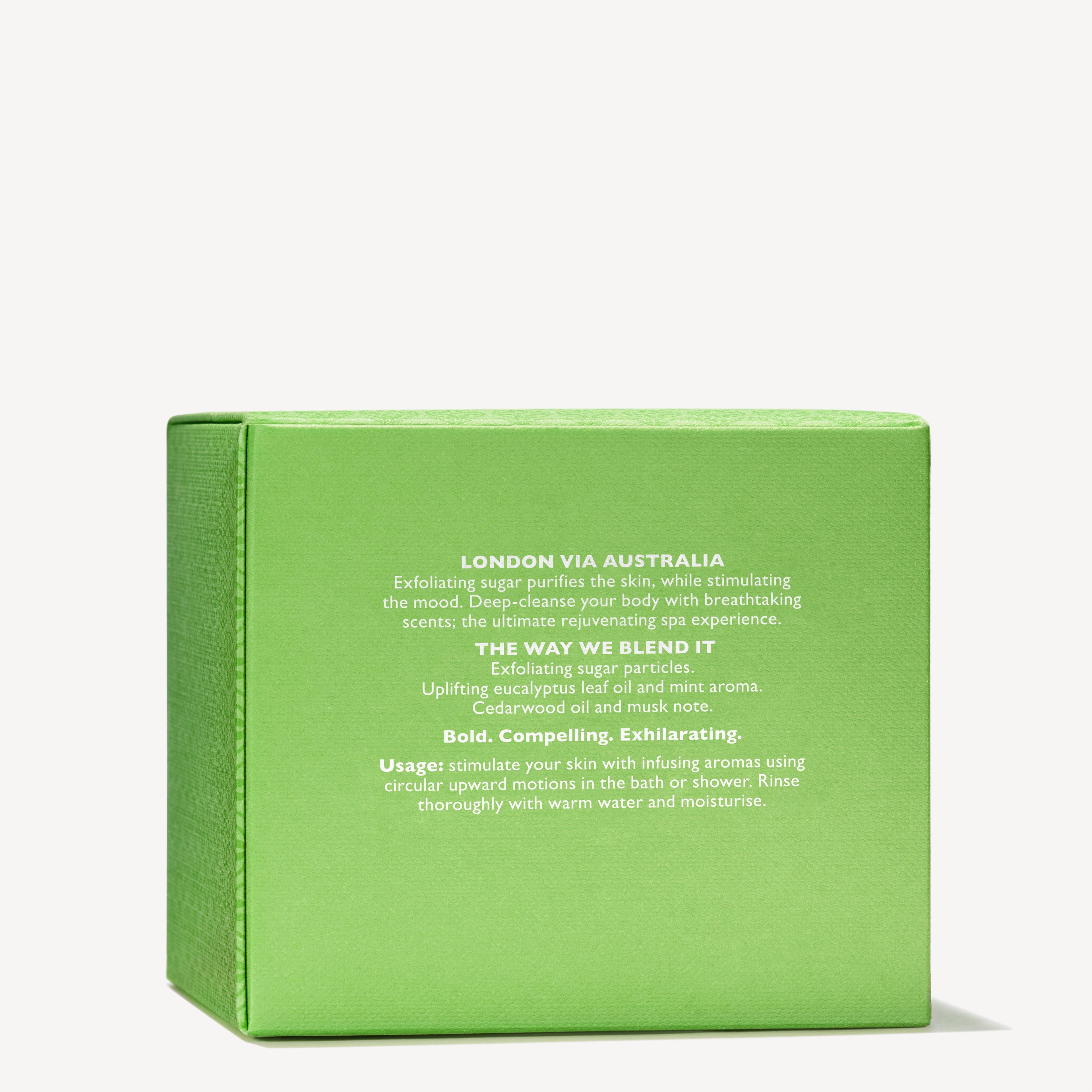 The MoltonBrown Nederlands Infusing Eucalyptus Stimulating Body Polisher 275g comes in a green box with white text and features exfoliating sugar, eucalyptus, mint, jojoba beads, and a woody-citrus scent for use in bath or shower.