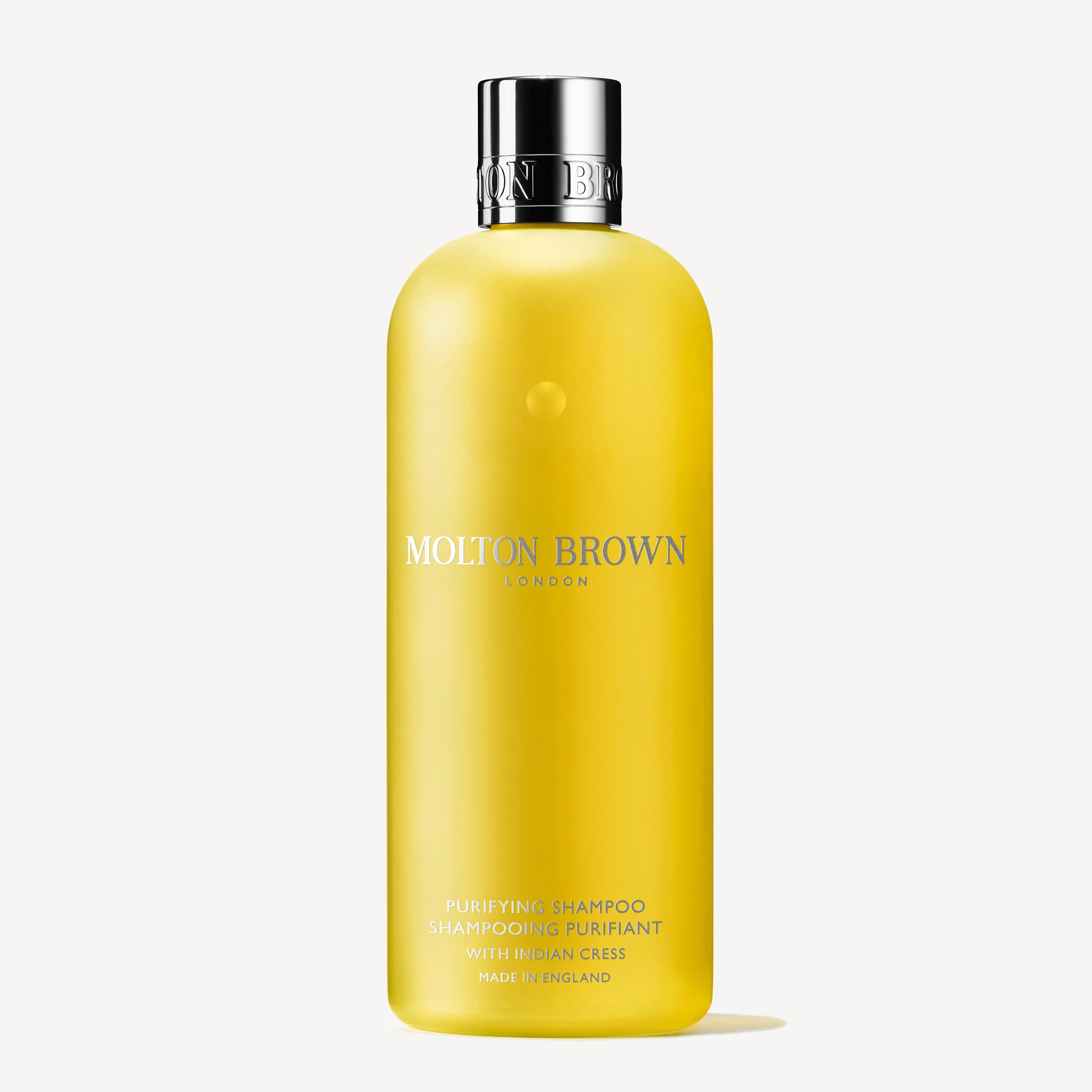 A yellow 300ml MoltonBrown Nederlands Purifying Shampoo With Indian Cress, featuring a silver cap and minimal white and gold text, is shown on a plain white background for a glanzend haar effect.
