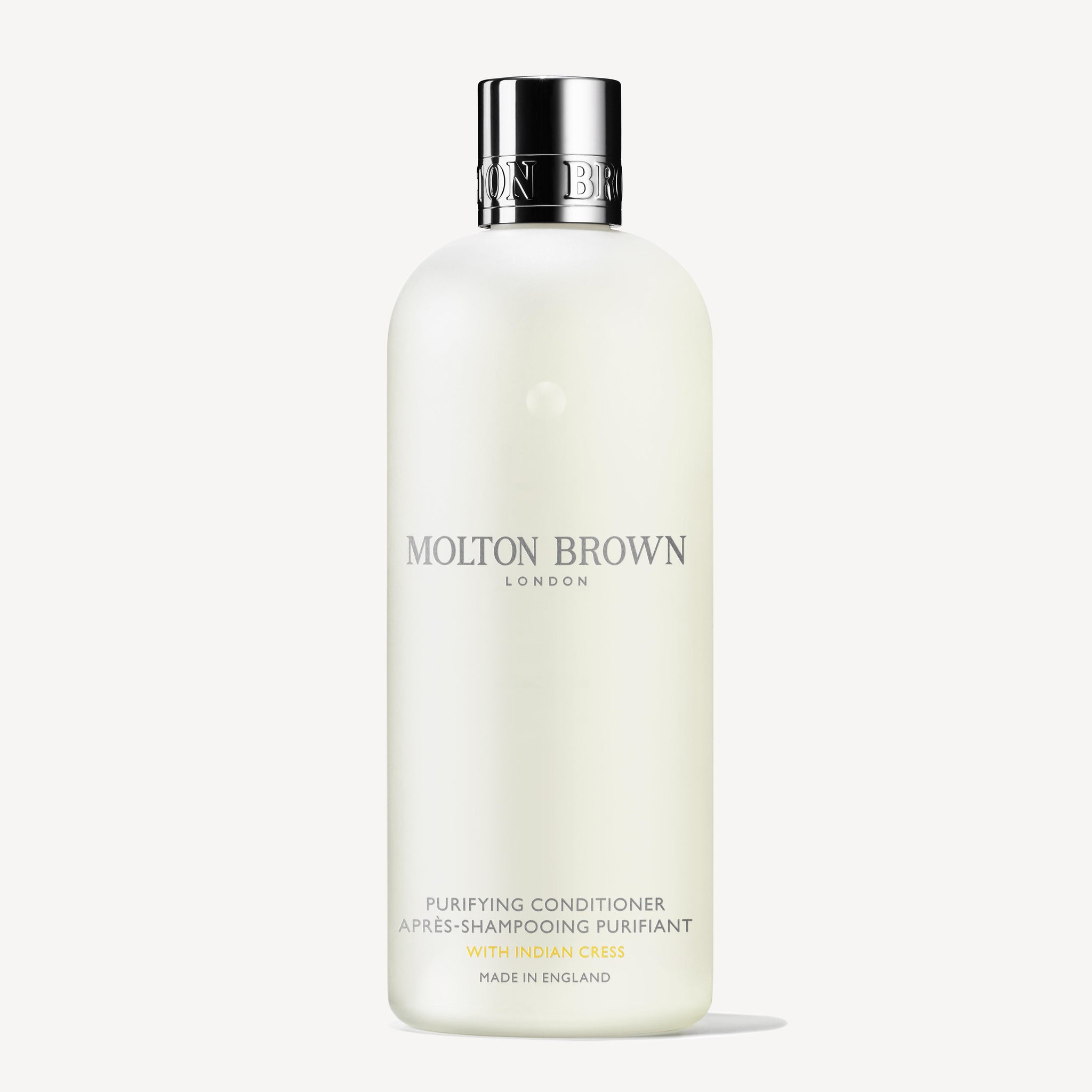 A white 300ml bottle of MoltonBrown Nederlands Purifying Conditioner With Indian Cress, featuring a silver cap and minimalist label text, displayed on a plain white background.