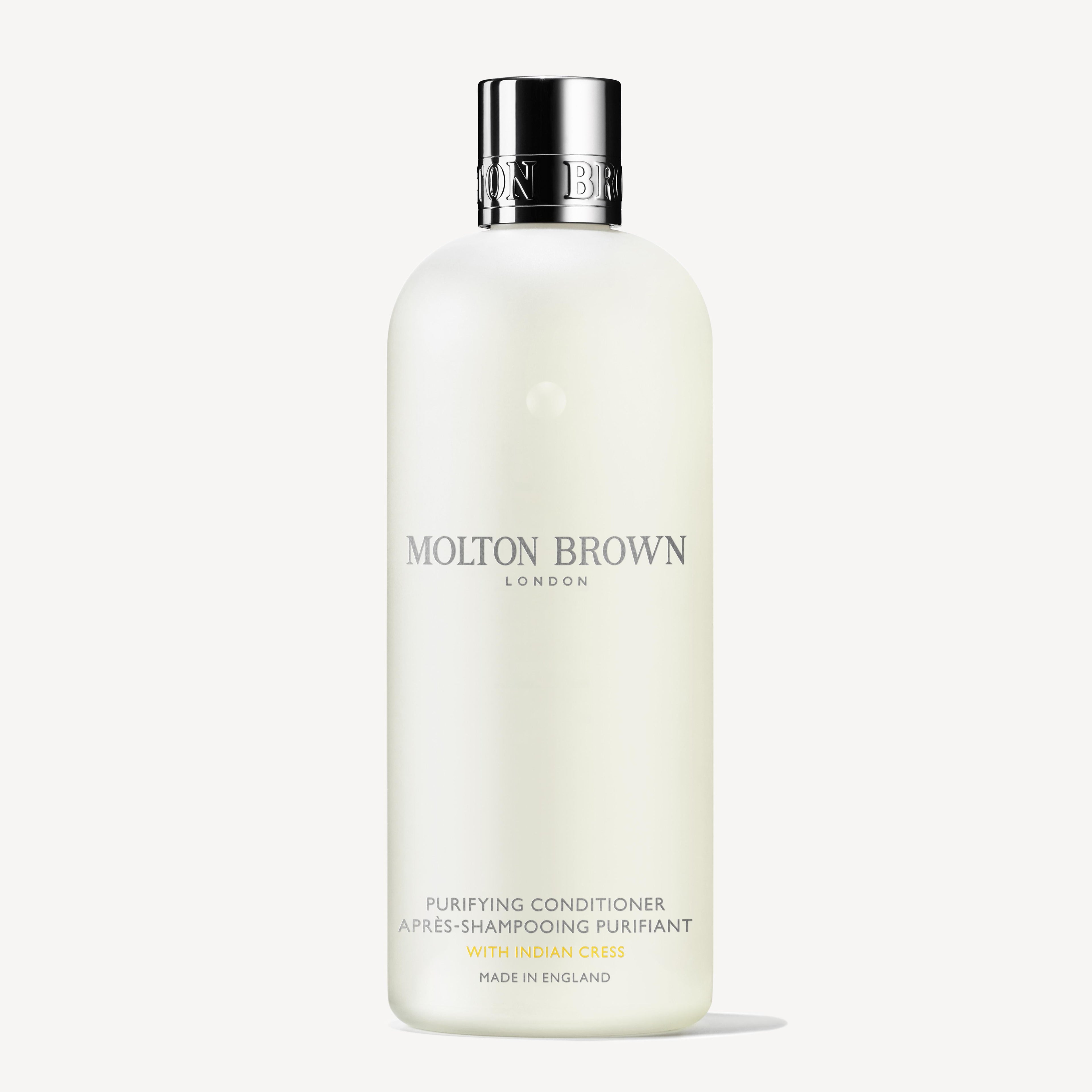 A white 300ml bottle of MoltonBrown Nederlands Purifying Conditioner With Indian Cress, featuring a silver cap and minimalist label text, displayed on a plain white background.