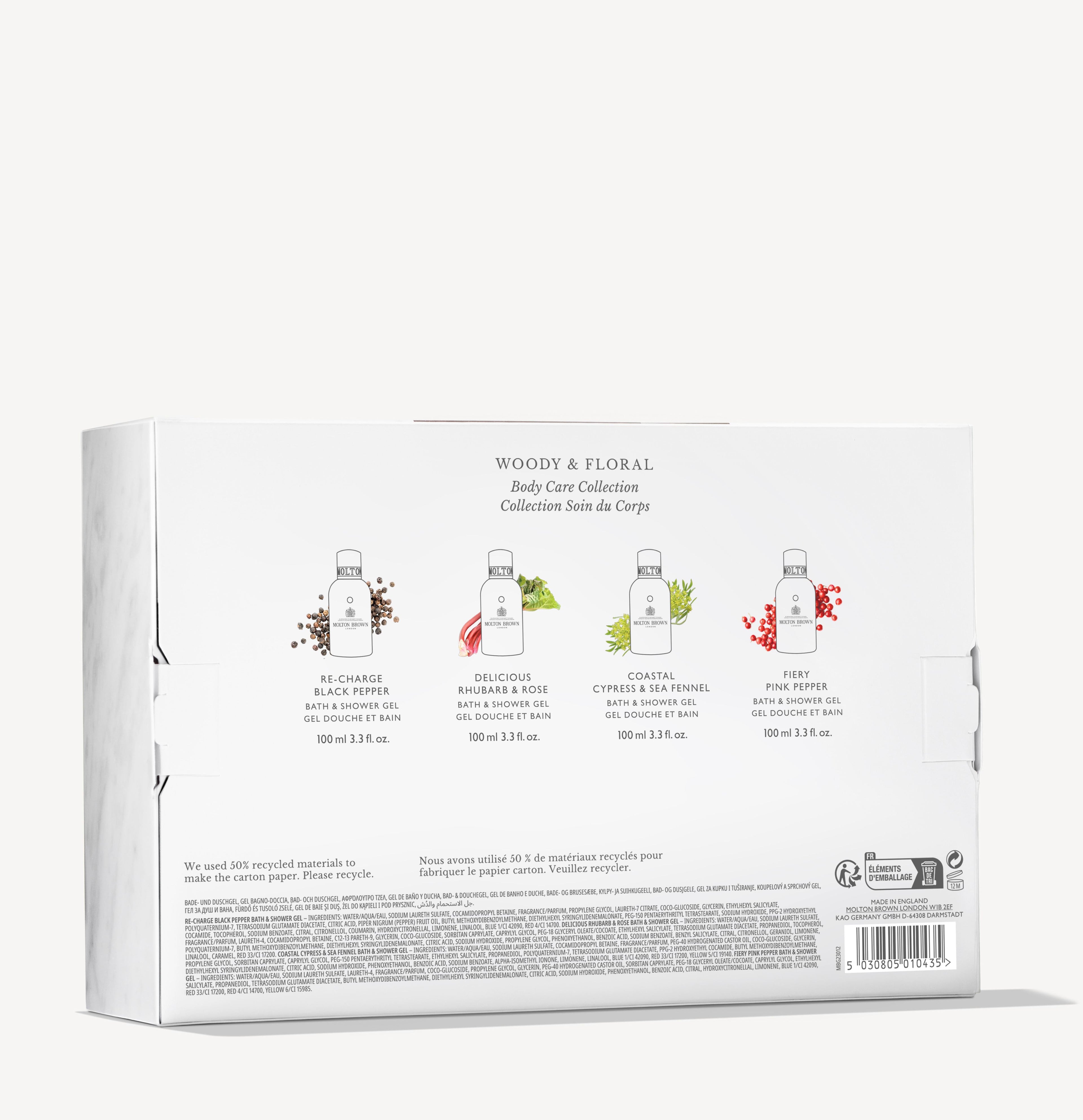 Back of a white box shows four MoltonBrown Nederlands Woody & Floral Body Verzorgingscollectie products—douchegel and bodylotion—with images of black pepper, hibiscus & rose, cypress & venkel, and pink pepper.