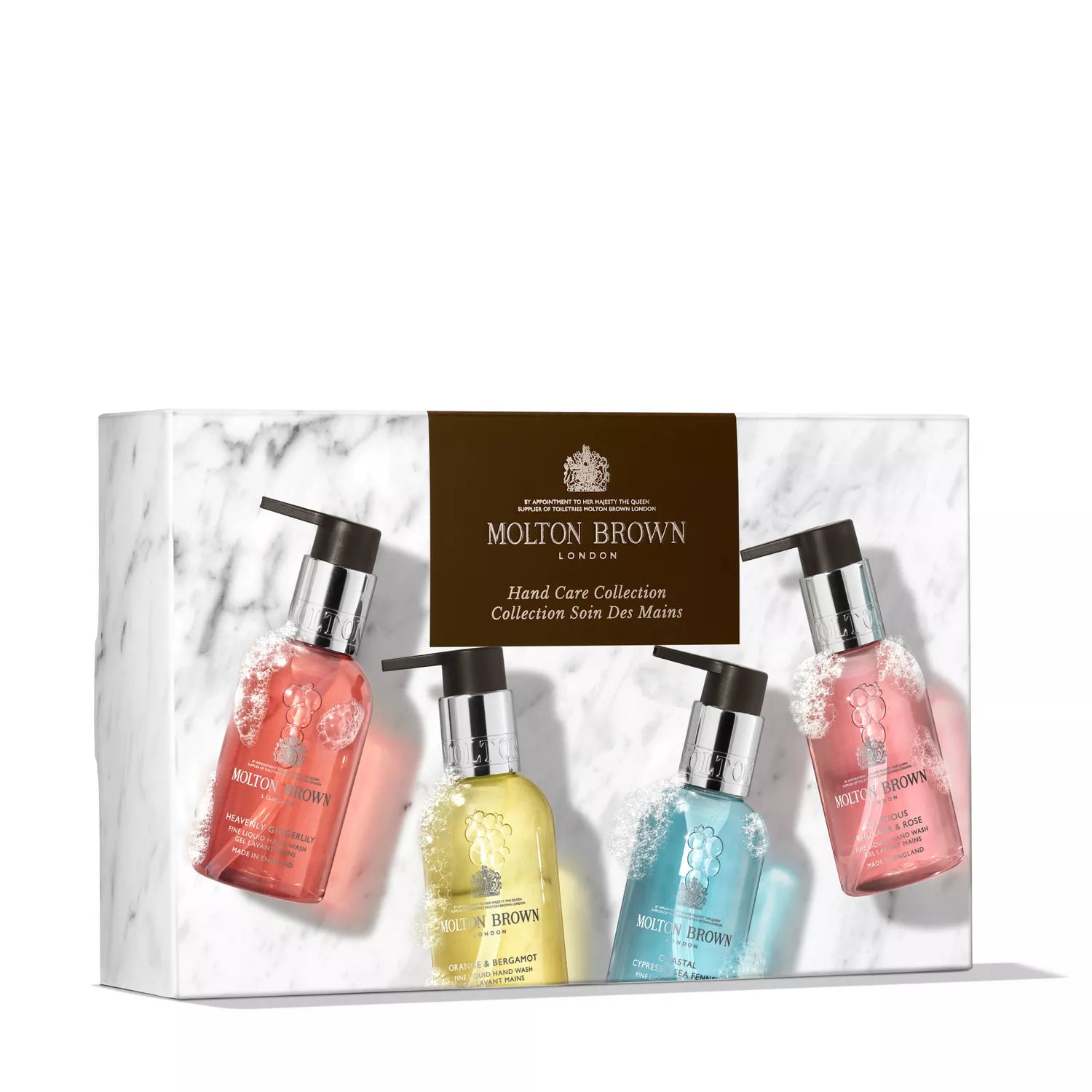 A boxed set of four MoltonBrown Nederlands Fresh & Floral Hand Verzorgingscollectie handzeep and handlotion in pump bottles, displayed on marble-patterned background with a brown label reading “Hand Care Collection.”.