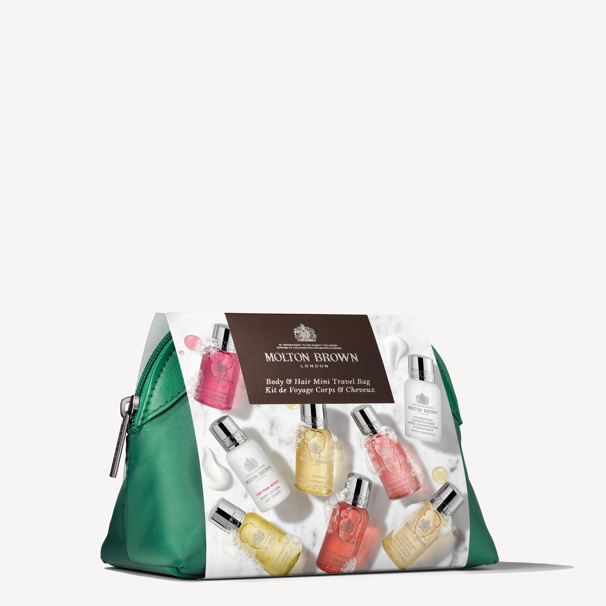 The Elegant Escapist Body & Hair Mini Reistas by MoltonBrown Nederlands: a green zippered bag with a luxe label, featuring assorted vibrant mini body and hair care bottles in travel sizes arranged around it.