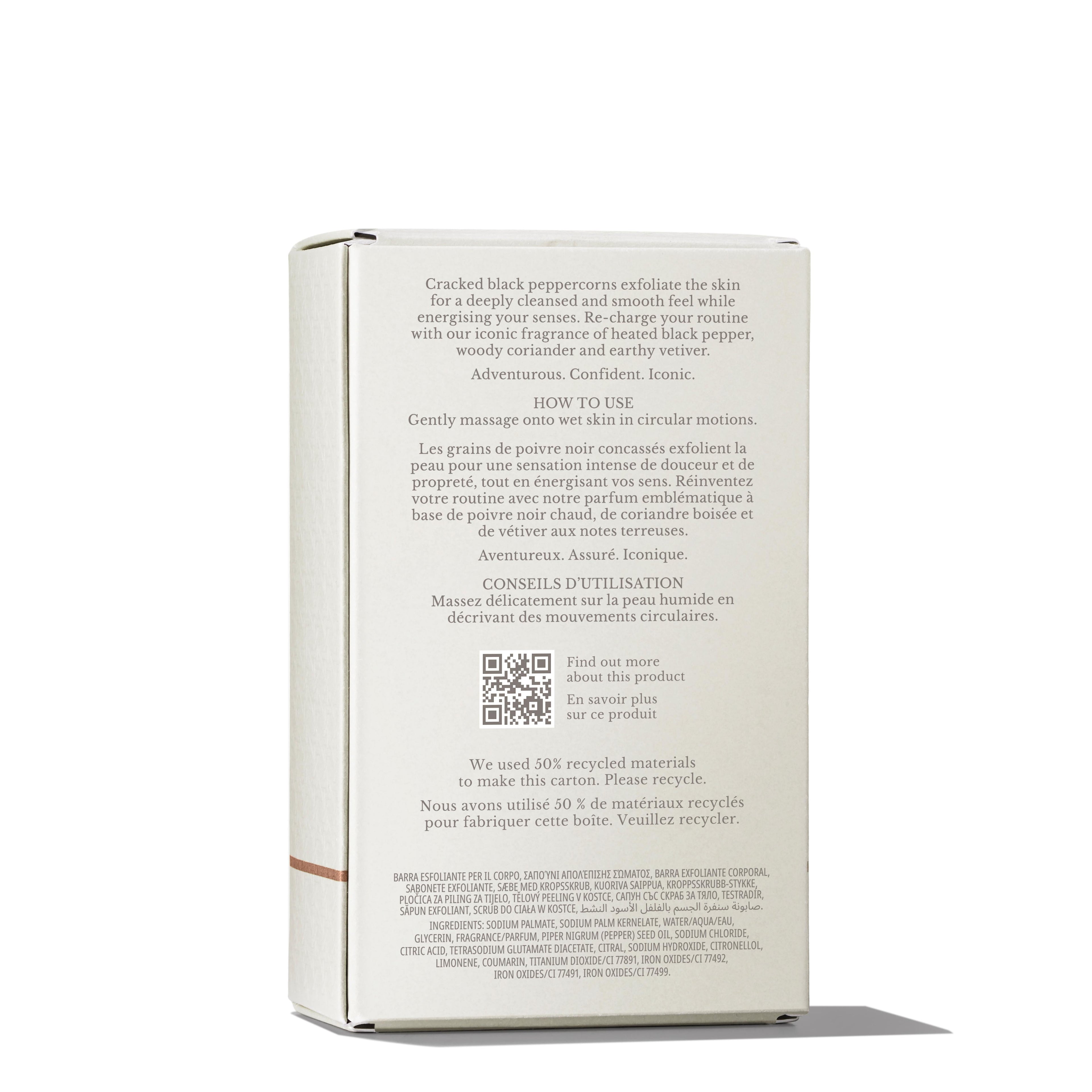 A beige MoltonBrown Nederlands Re-charge Black Pepper Bodyscrub Bar 250g box stands upright, featuring exfoliating details with cracked black peppercorns, jojoba beads, nourishing oils, and bilingual use, recycling, and ingredient information.