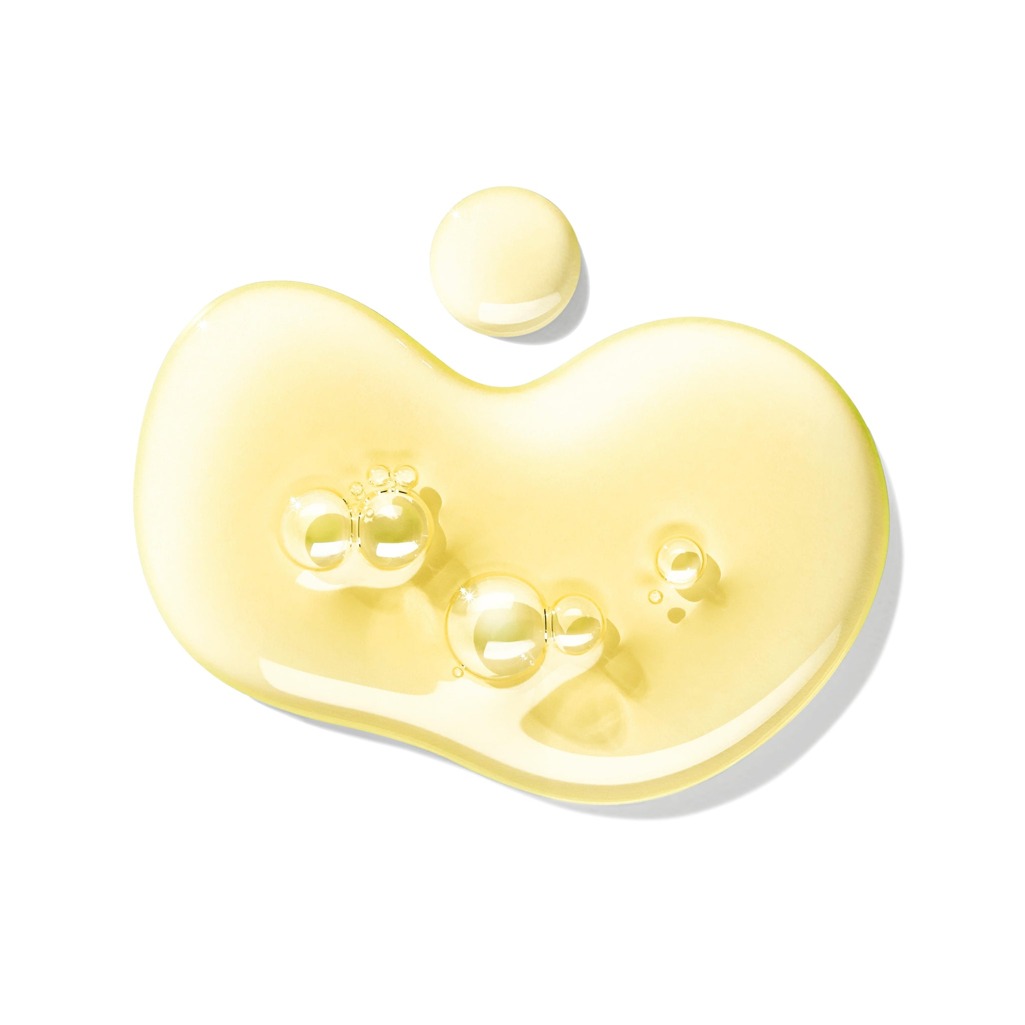 A close-up of a light yellow drop with small bubbles, featuring the Orange & Bergamot Bad- & Douchegel 300ml by MoltonBrown Nederlands, shown on a white background.