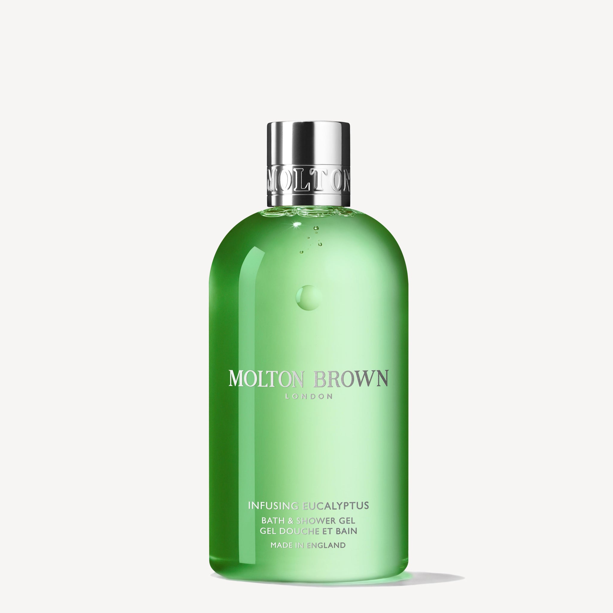 A green 300ml MoltonBrown Nederlands Infusing Eucalyptus Bad- & Douchegel bottle with a silver cap stands upright against a plain white background, highlighting its aromatische formule met botanische extracten.