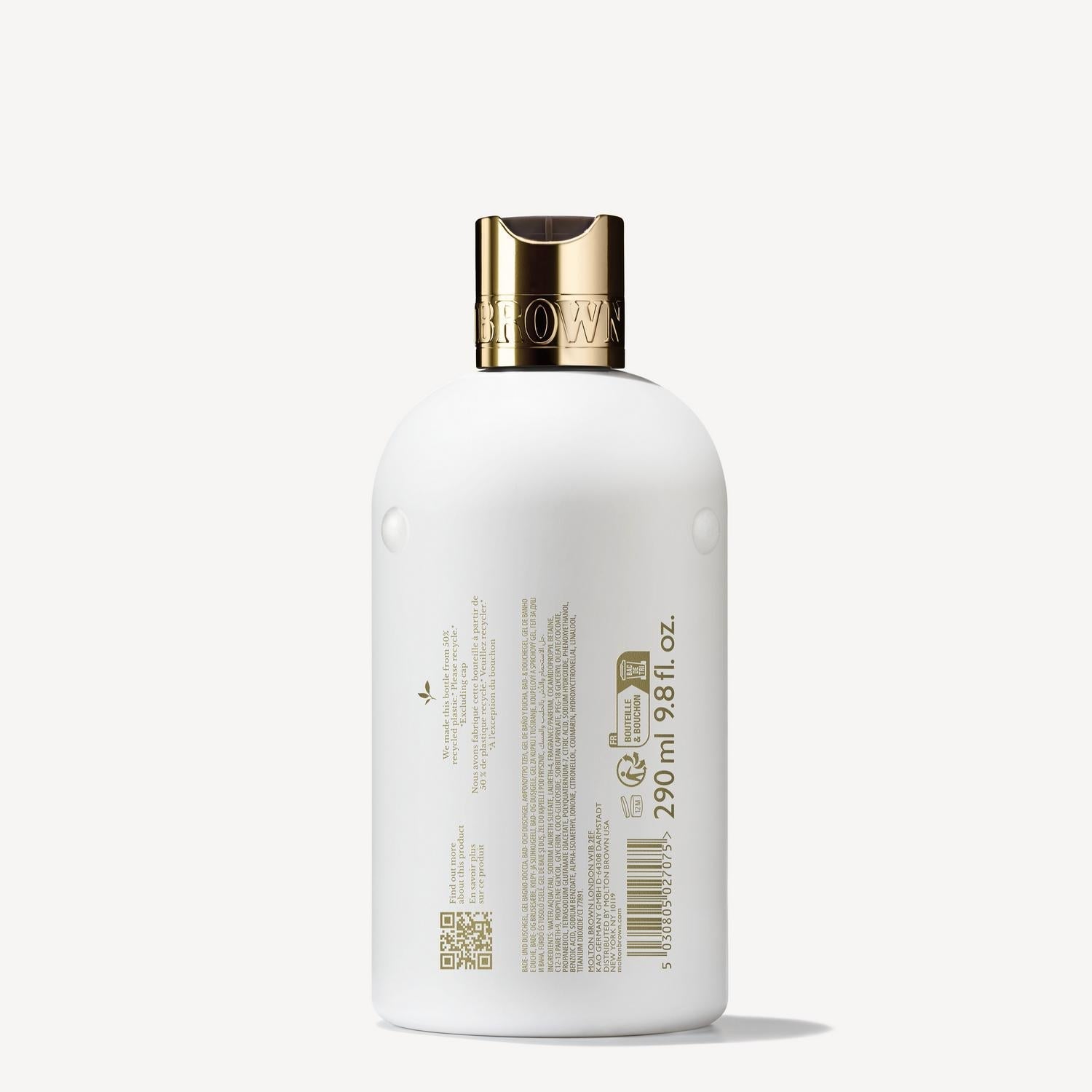 A white 300ml plastic bottle of MoltonBrown Nederlands Milk Musk Bad- & Douchegel, shown from the back, with a gold cap. The label displays product info, barcodes, and branding in gold and brown text with a sensueel musk note.