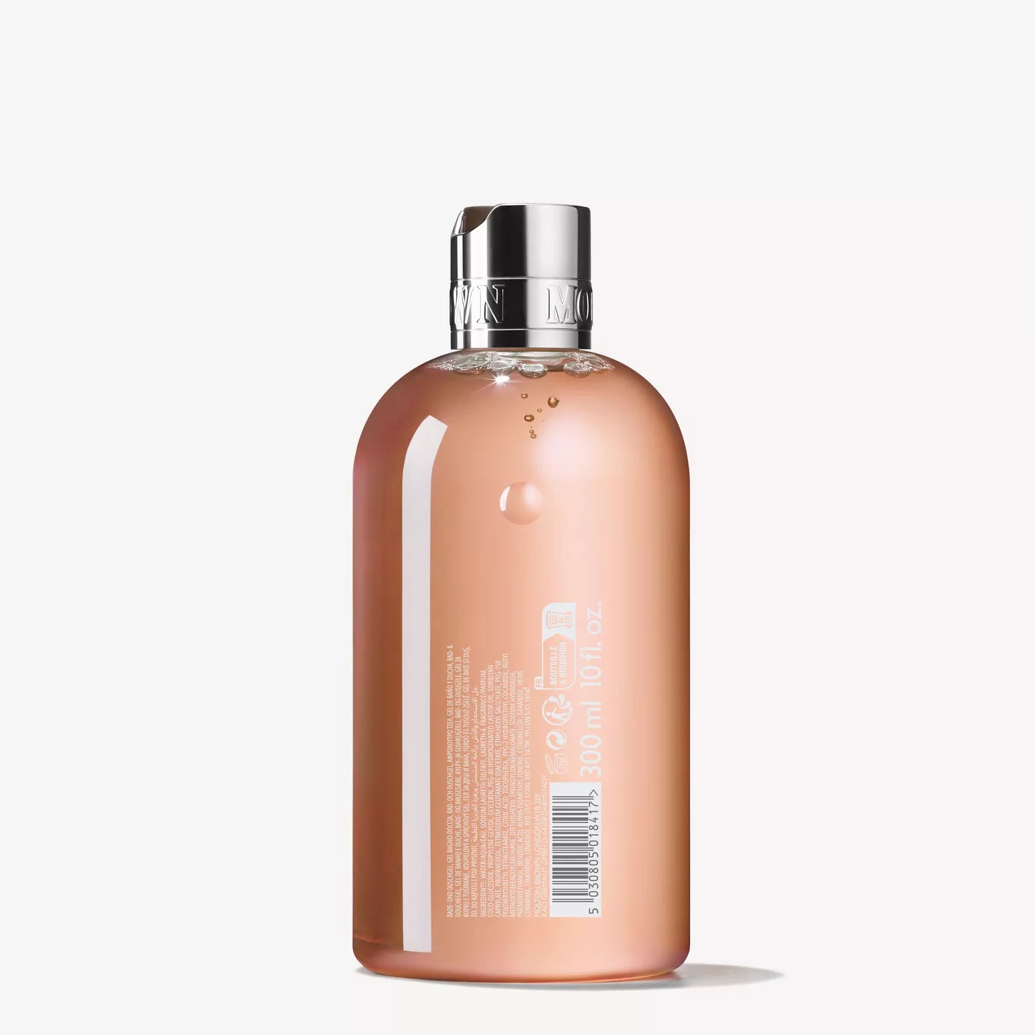 A clear 150g bottle of MoltonBrown Nederlands Fiery Pink Pepper Perfumed Soap with a silver cap and measurement markings. The back label displays product info and a barcode. The bottle stands upright against a plain white background.