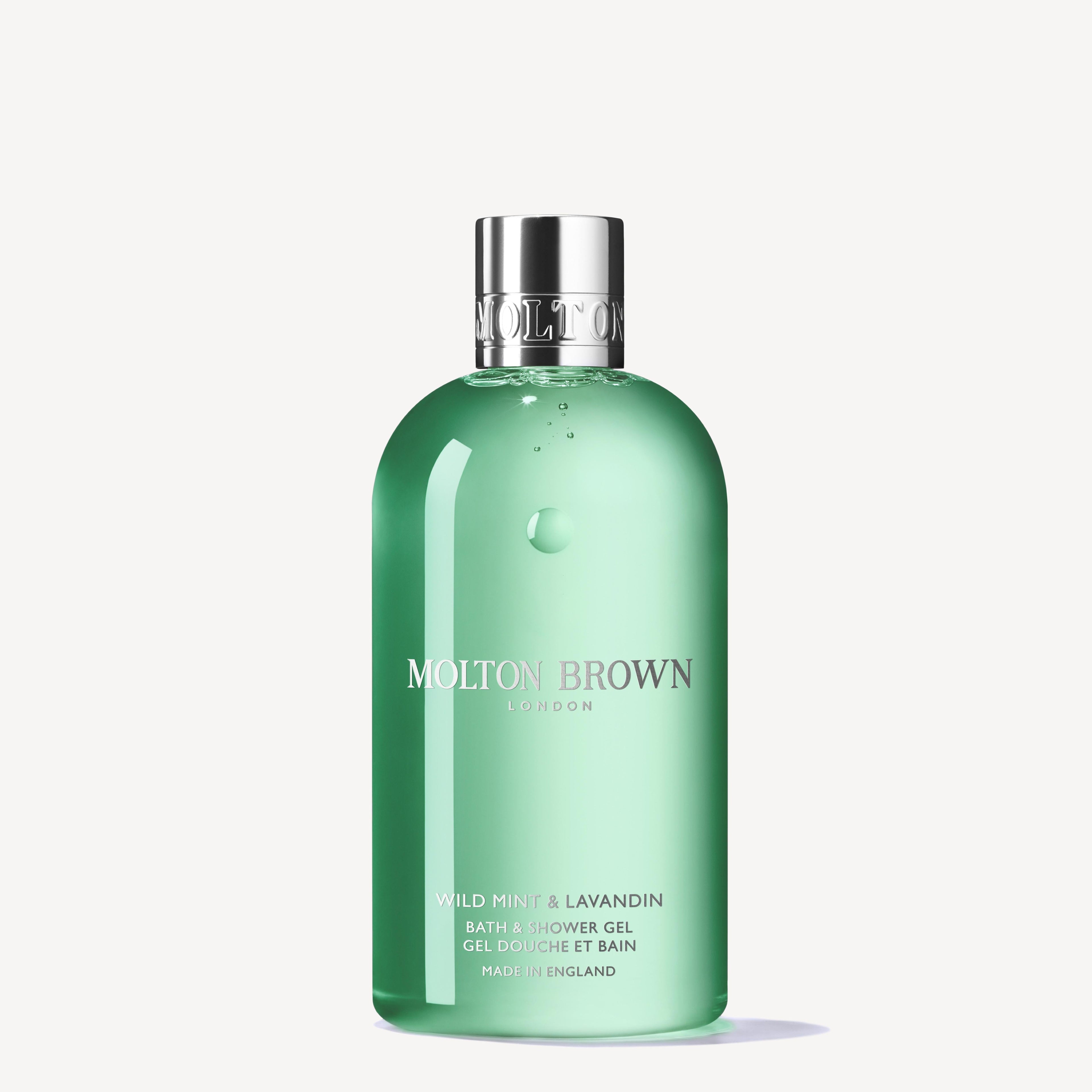 A 300ml green bottle of MoltonBrown Nederlands Wild Mint & Lavandin Bad- & Douchegel, topped with a silver cap, is displayed against a plain white background.