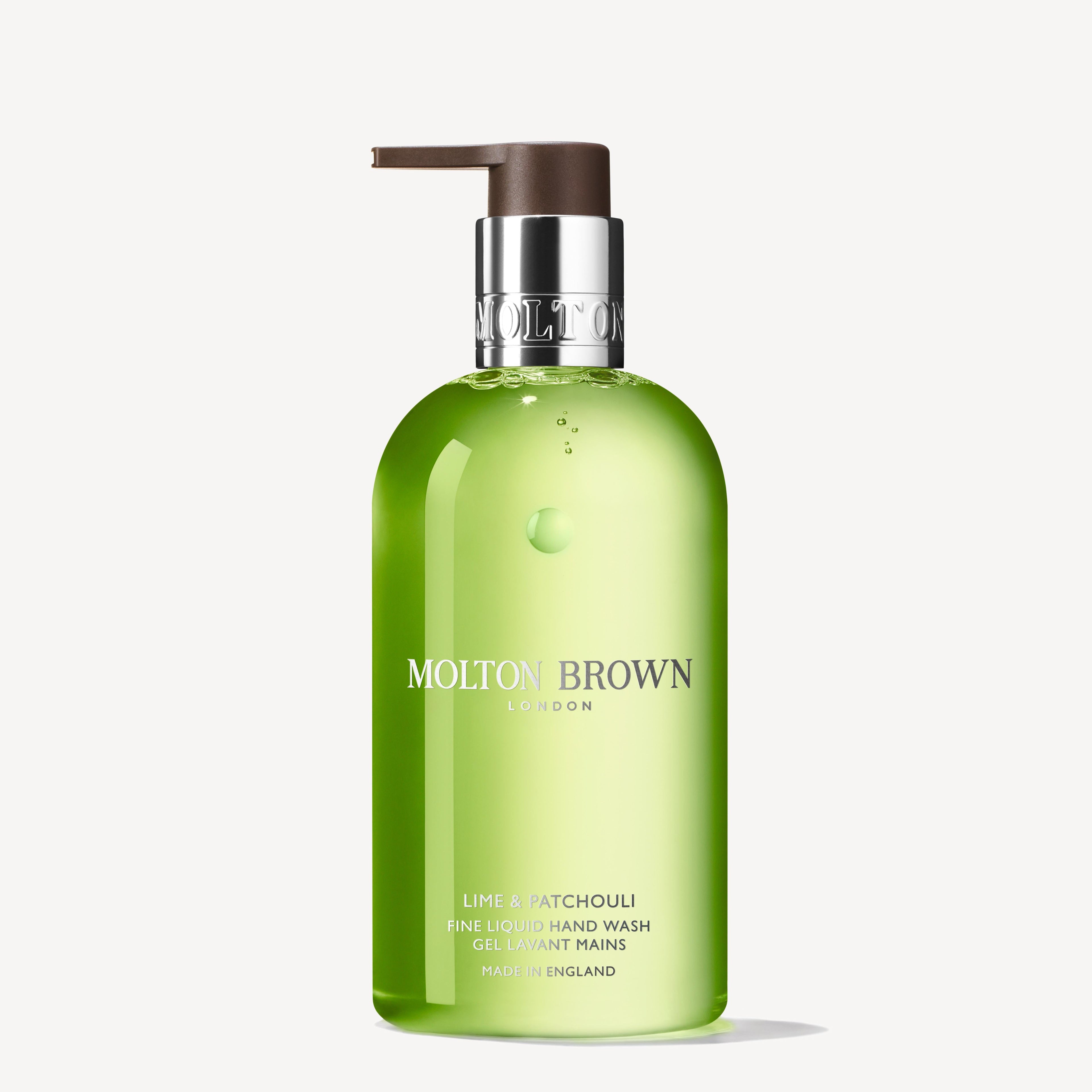 A 300ml green bottle of MoltonBrown Nederlands Lime & Patchouli Vloeibare Handzeep with a silver collar and brown pump, featuring the scent of fresh lime and patchouli, set against a plain white background.