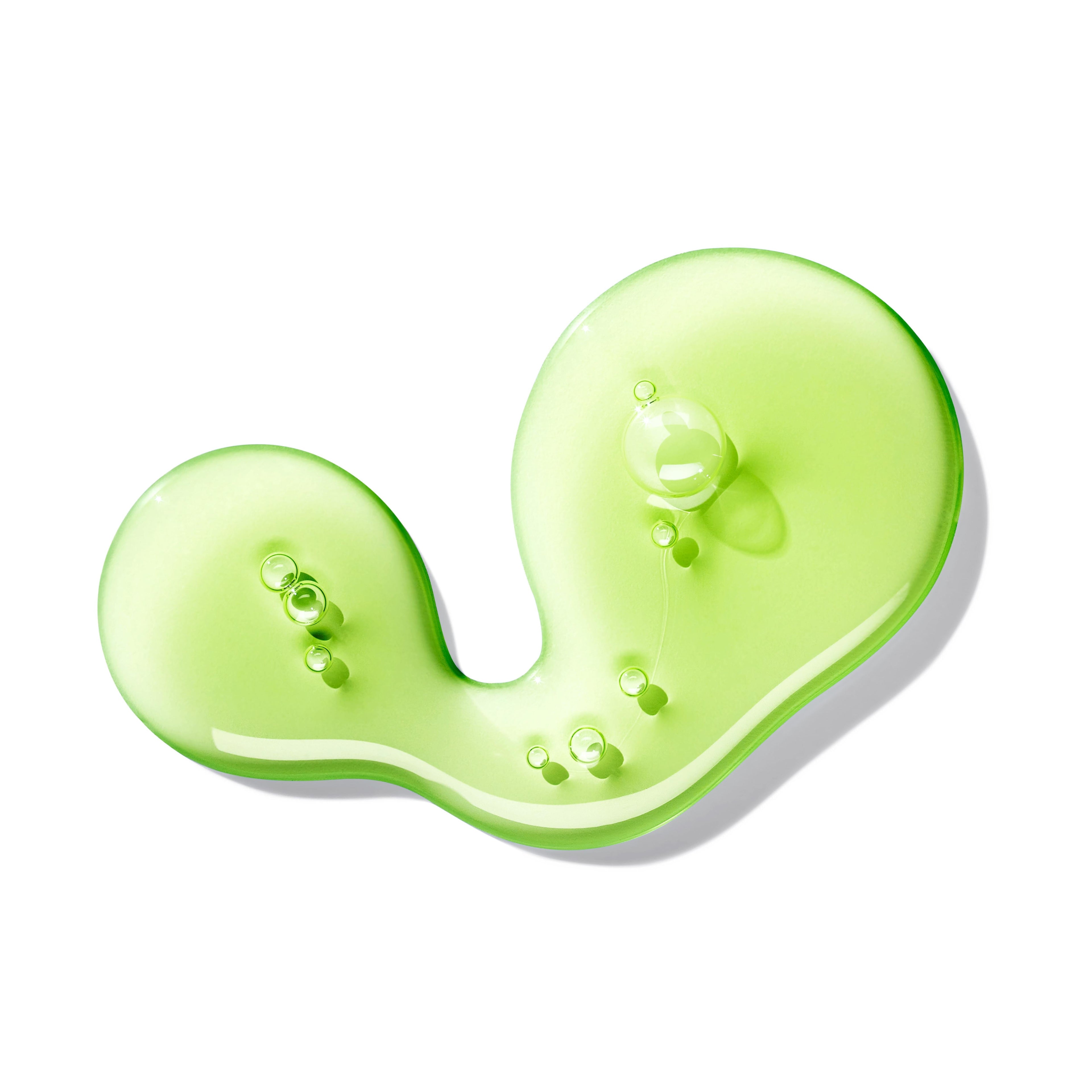 A green, translucent gel blob with small bubbles, shaped abstractly, evokes the scent of frisse limoen and patchouli—MoltonBrown Nederlands Lime & Patchouli Vloeibare Handzeep 300ml—displayed on a white background.