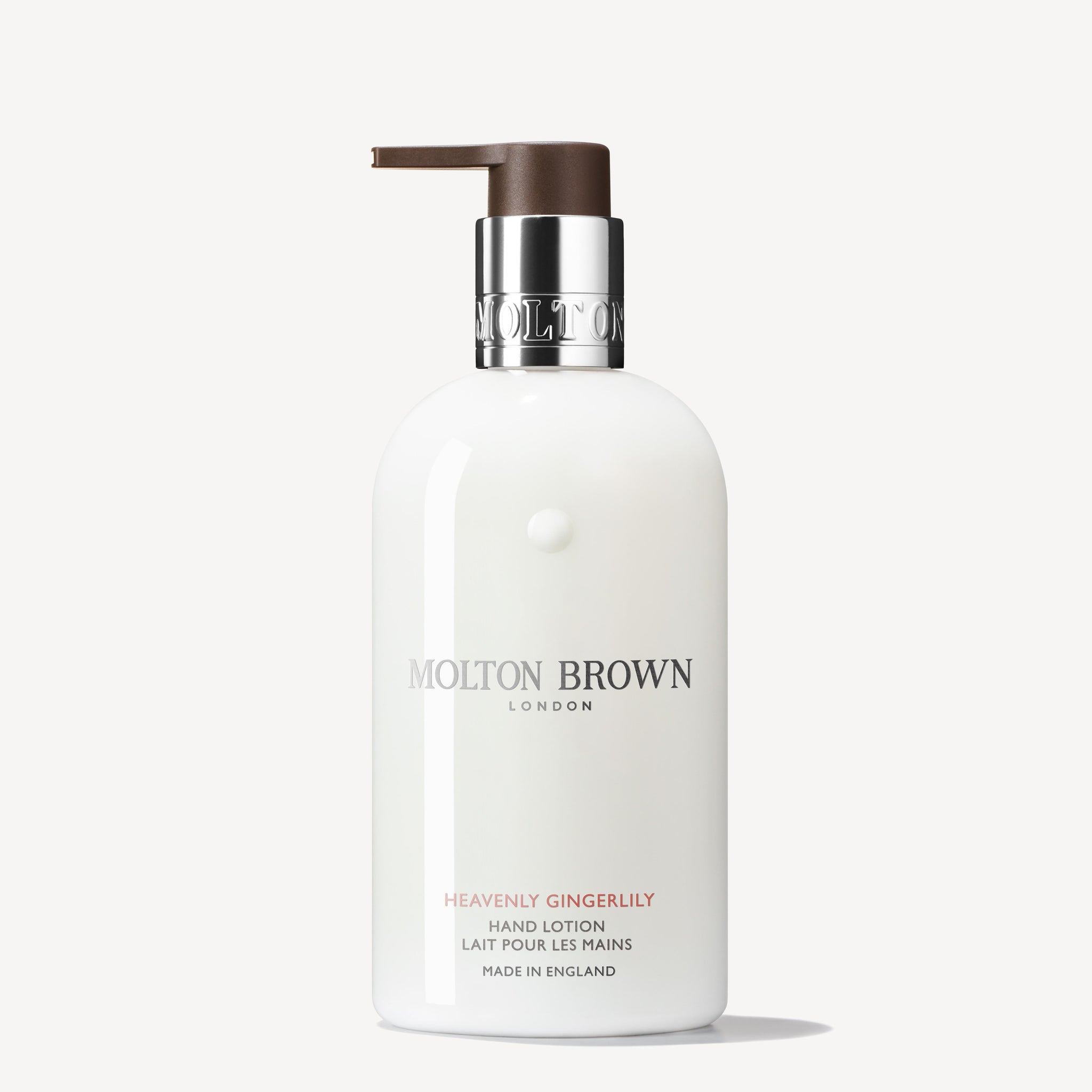 A white 300ml MoltonBrown Nederlands Heavenly Gingerlily Handlotion with a brown pump and silver collar, featuring English and French text, is displayed on a plain white background.