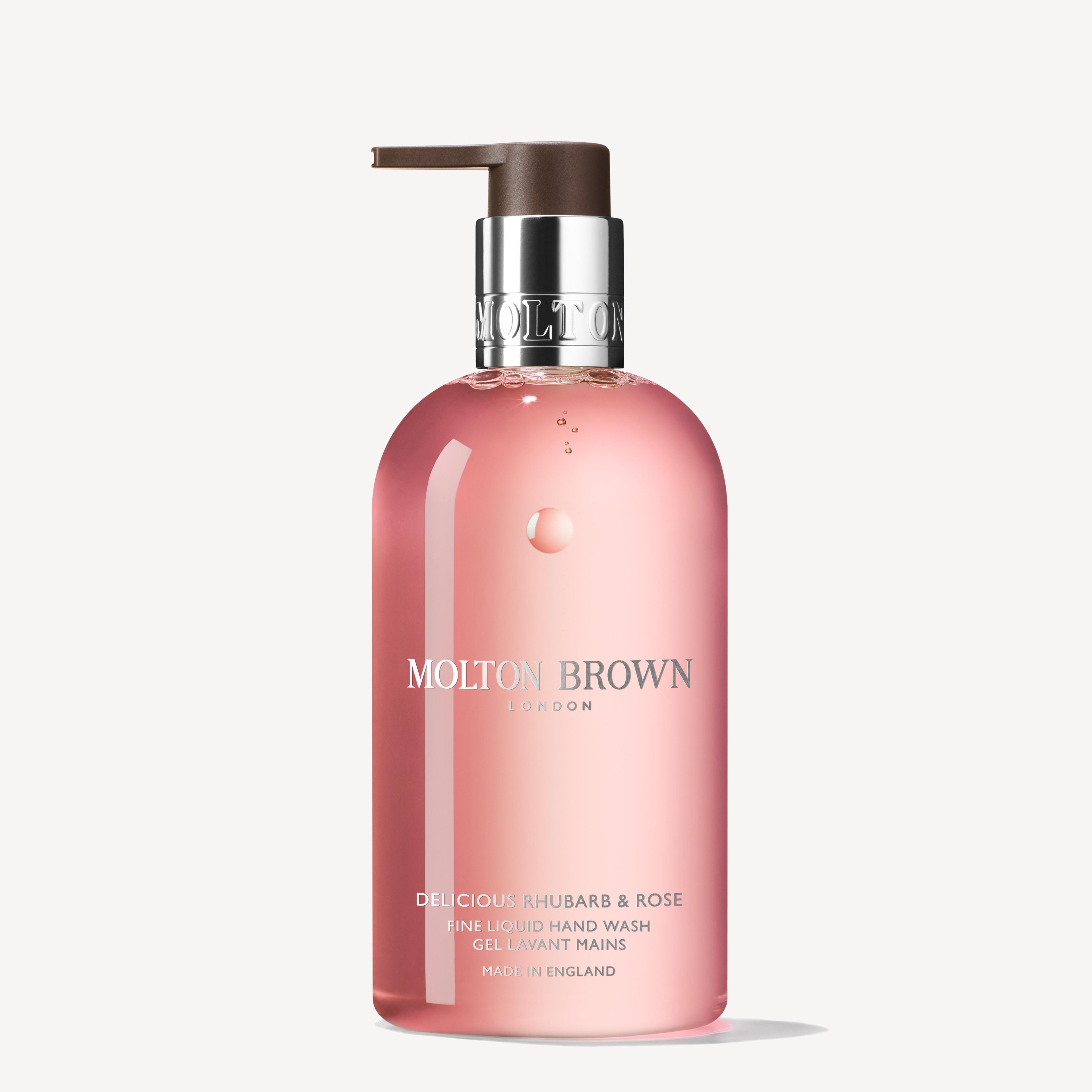 A pink bottle of MoltonBrown Nederlands Delicious Rhubarb & Rose Vloeibare Handzeep 300ml with a bloemig-fruitig geur, brown pump dispenser, and elegant silver and white label text.