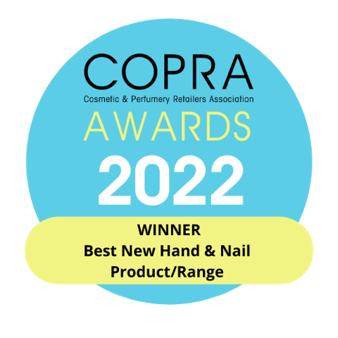A blue circular badge reads “COPRA AWARDS 2022 WINNER Best New Hand & Nail Product/Range” under Cosmetic & Perfumery Retailers Association, celebrating our Flora Luminare Vloeibare Handzeep 300ml by MoltonBrown Nederlands.