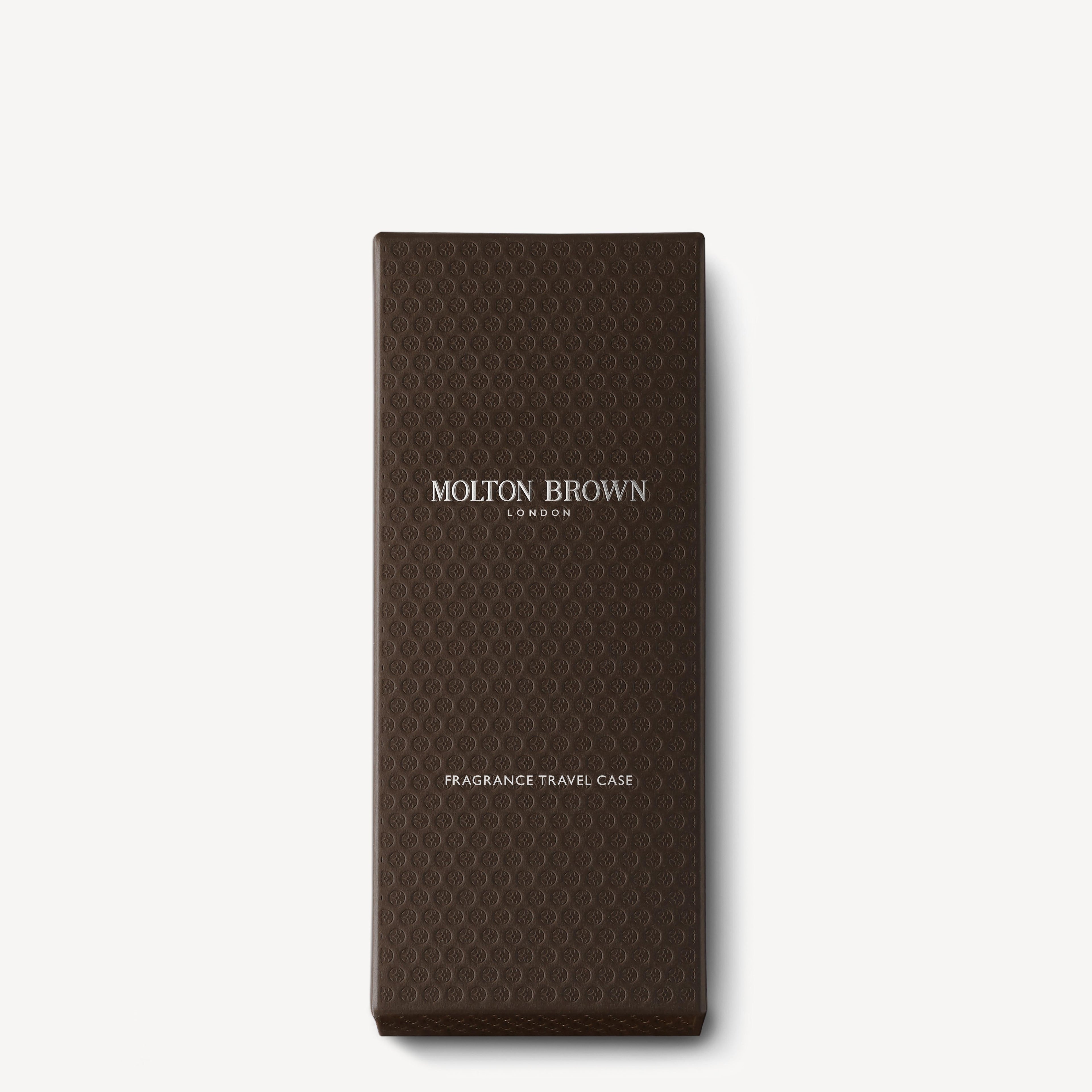 A dark brown textured rectangular box with "MoltonBrown Nederlands" in white at the center and "Fragrance Reiskoffer" near the bottom, inspired by jasmijn scents and enriched with witte moerbei extract. Set on a plain white background.
