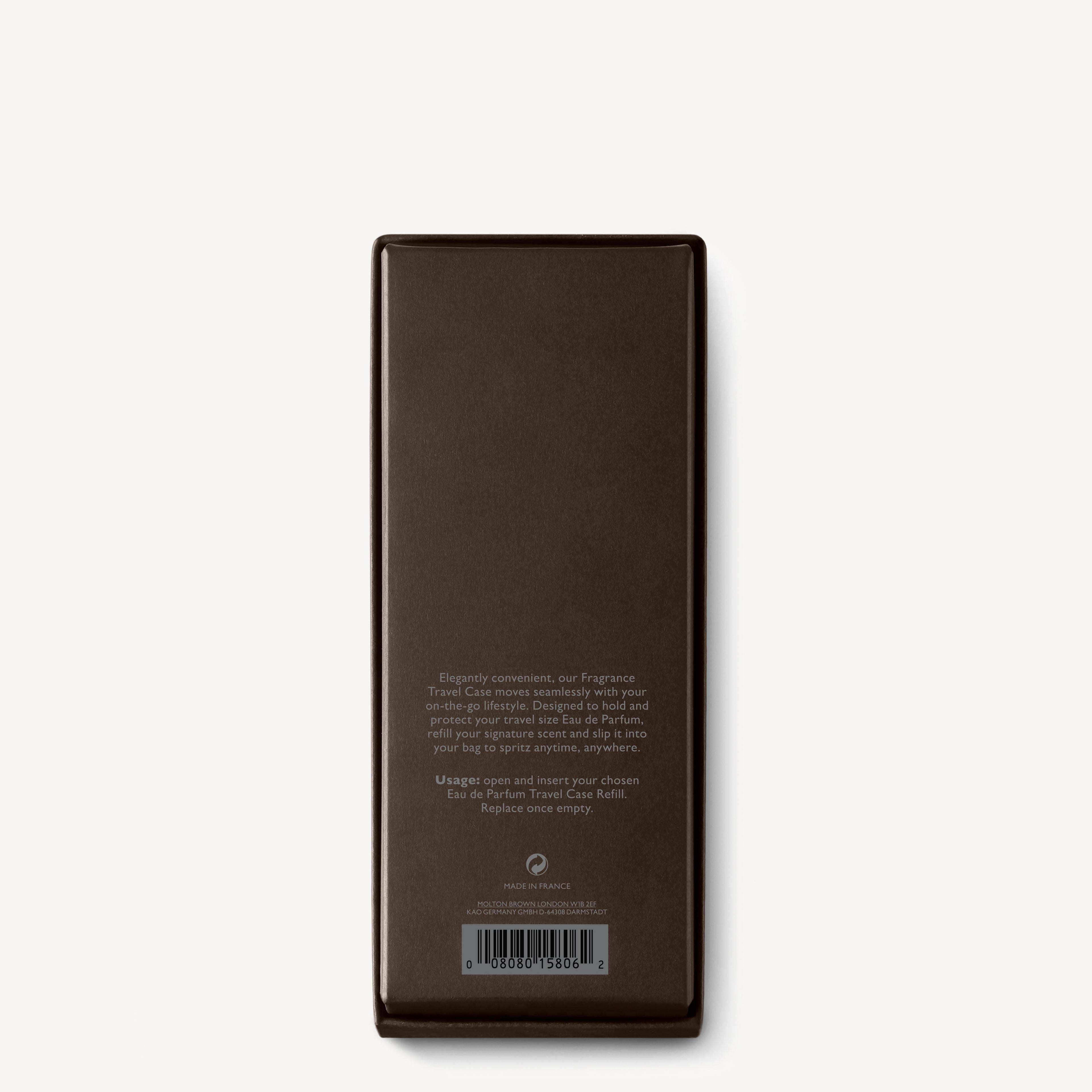 A rectangular, dark brown MoltonBrown Nederlands Fragrance Reiskoffer box stands upright on a white background. Centered white text on the back details handzeep with witte moerbei extract and jasmijn, plus a barcode at the bottom.