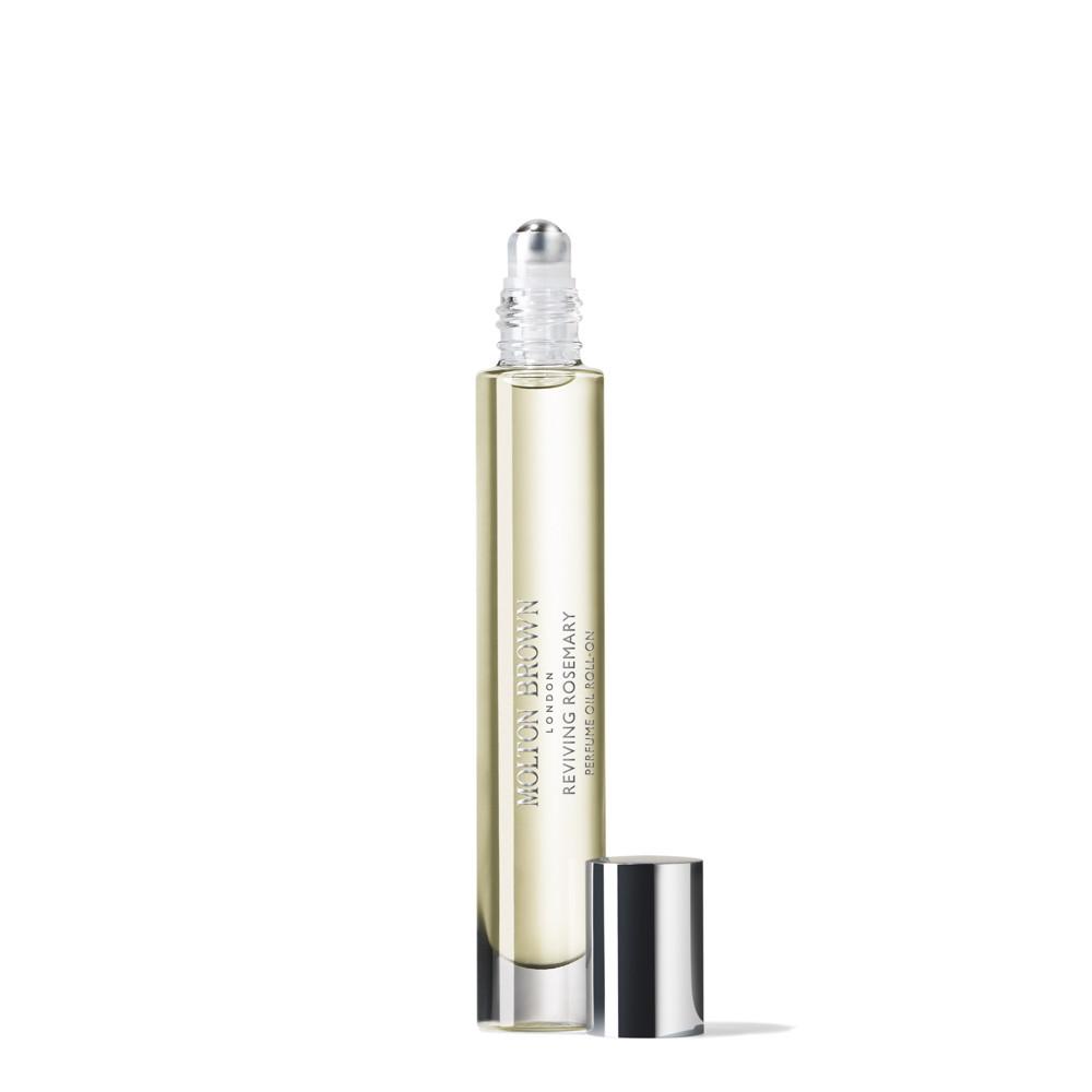 A clear glass rollerball bottle with pale yellow liquid and a silver cap beside it. The label reads MoltonBrown Nederlands Reviving Rosemary Parfumolie Roll-On with notes of jasmijn and witte moerbei extract on a white background.