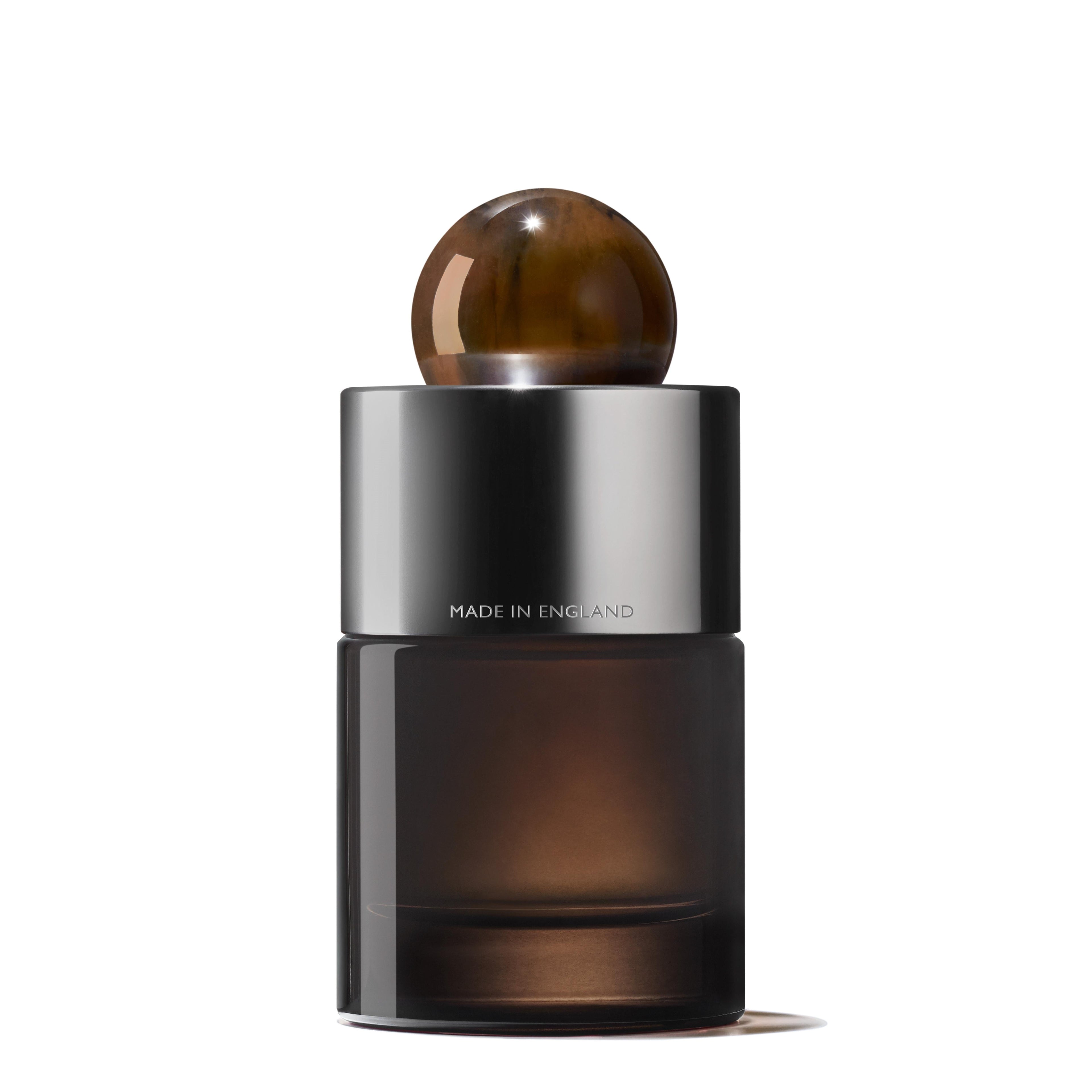 The MoltonBrown Nederlands Re-charge Black Pepper Eau de Parfum 100ml features a sleek dark glass bottle with a metallic silver collar, round brown cap, and "MADE IN ENGLAND" label, set against a white background.