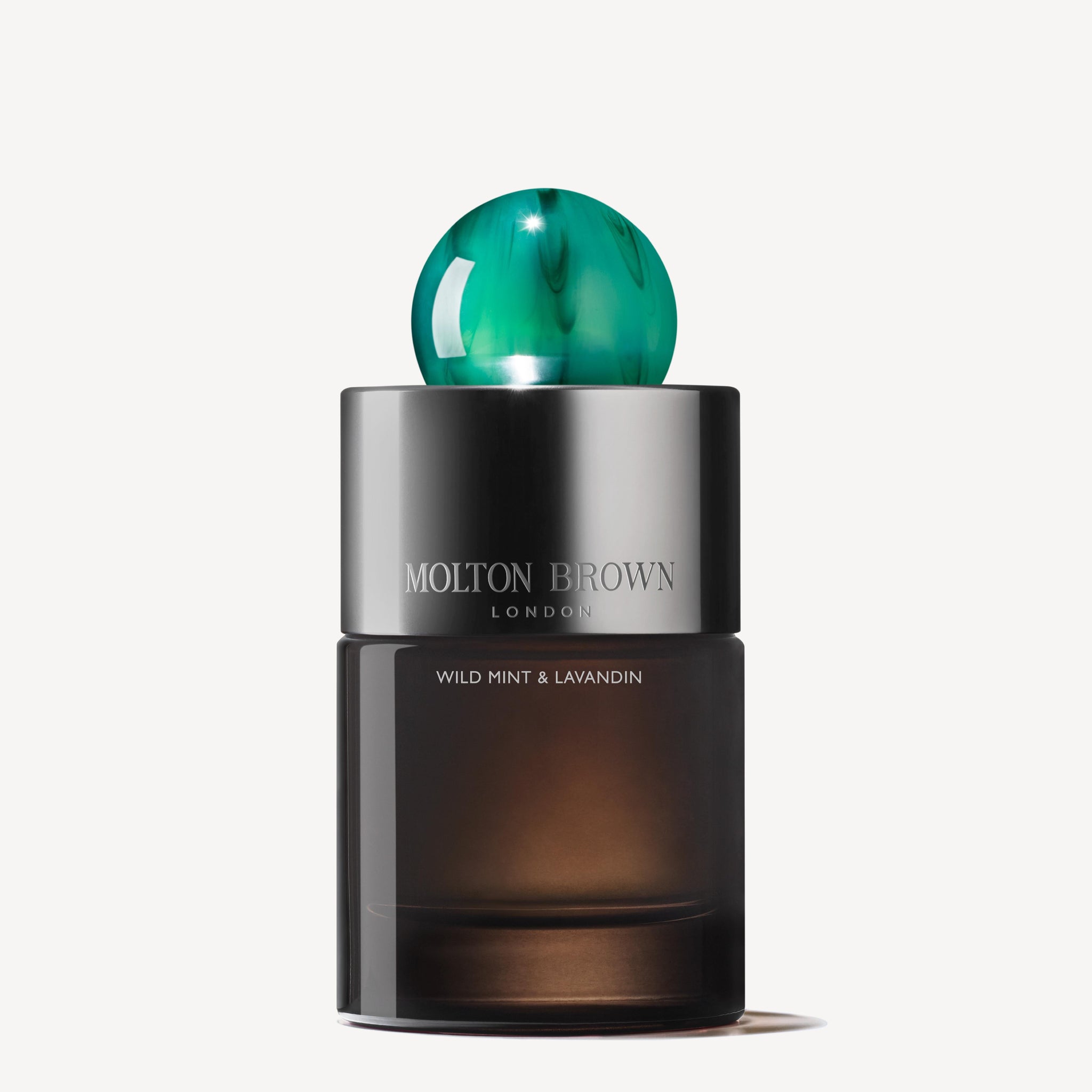 A 100ml bottle of MoltonBrown Nederlands Wild Mint & Lavandin Eau de Parfum features a dark glass base, silver detail, and a green marble-patterned cap, exuding fresh lavendel and wit-bloemige noten on a white background.