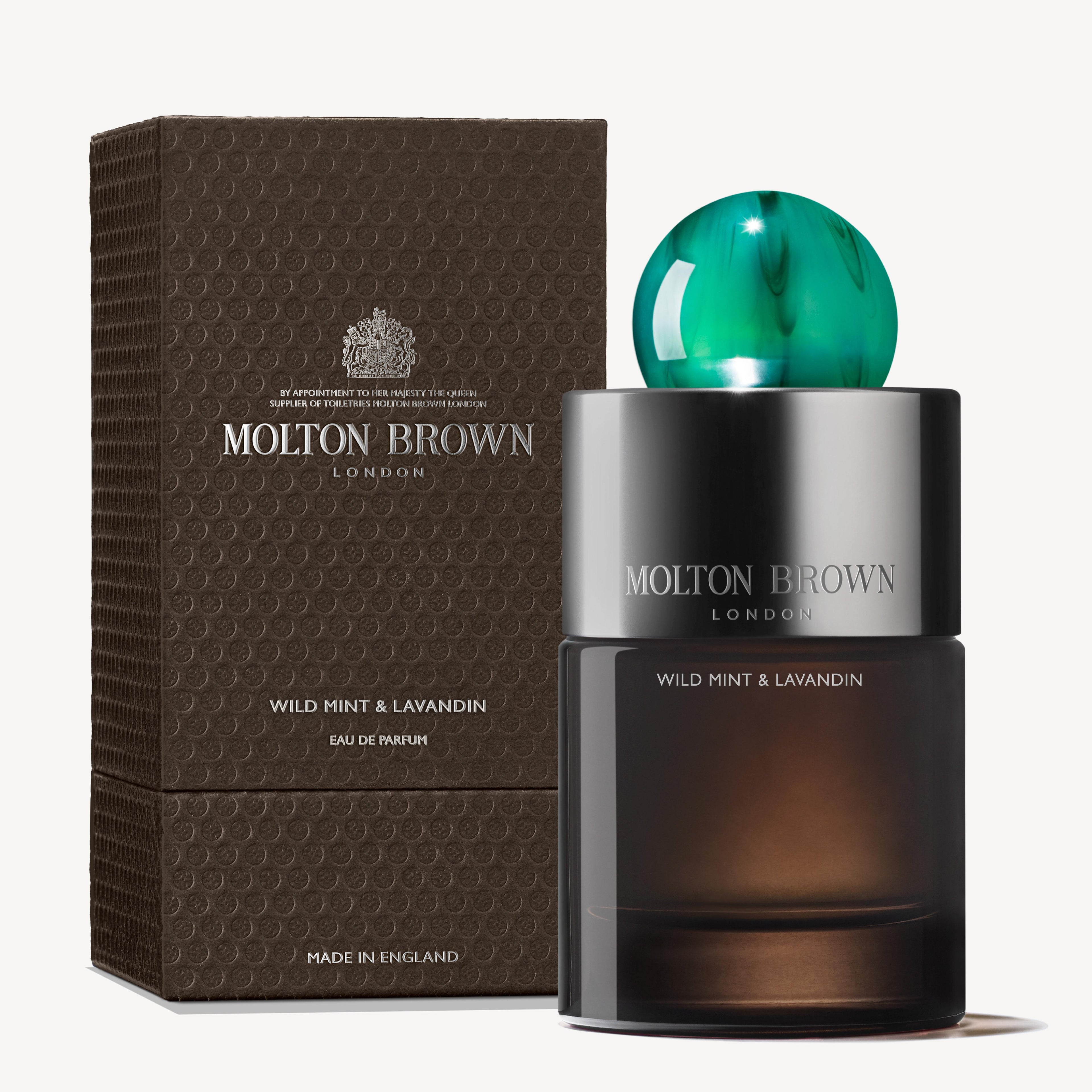 A MoltonBrown Nederlands Wild Mint & Lavandin Eau de Parfum 100ml stands before its textured brown box, featuring a metallic cap with a green top. The packaging reads "Molton Brown London" and "Made in England.