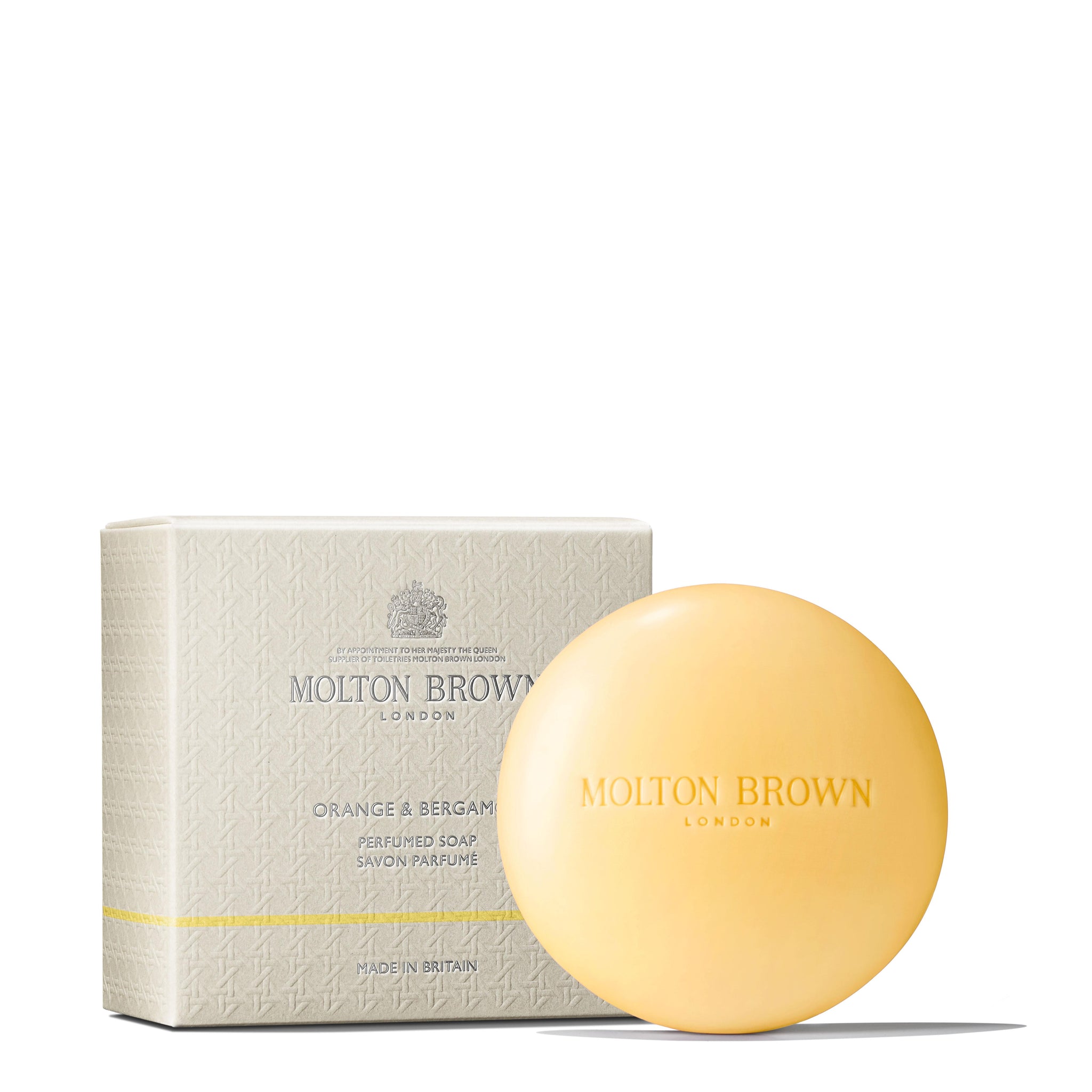 A round, pale orange bar of MoltonBrown Nederlands Orange & Bergamot Perfumed Soap 150g with natuurlijke oliën is shown before its textured, light beige box labeled with the brand and product name.