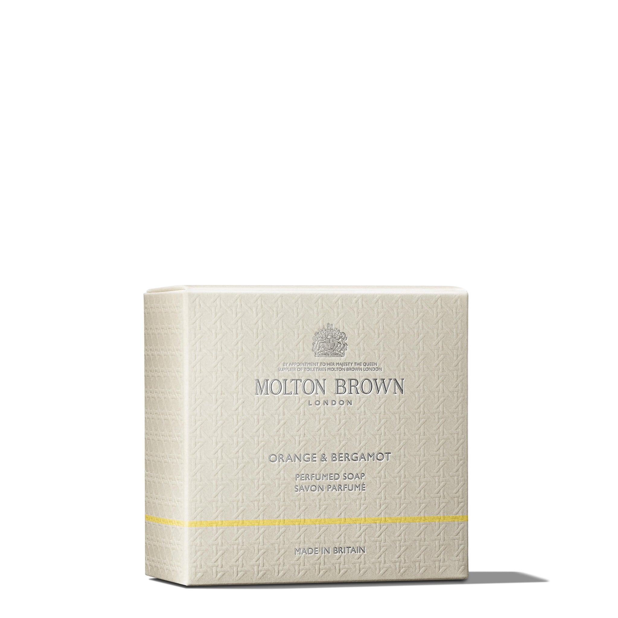 A beige box of MoltonBrown Nederlands Orange & Bergamot Perfumed Soap 150g, enriched with natuurlijke oliën, features textured patterns, silver text, and a thin yellow line near the bottom against a white background.