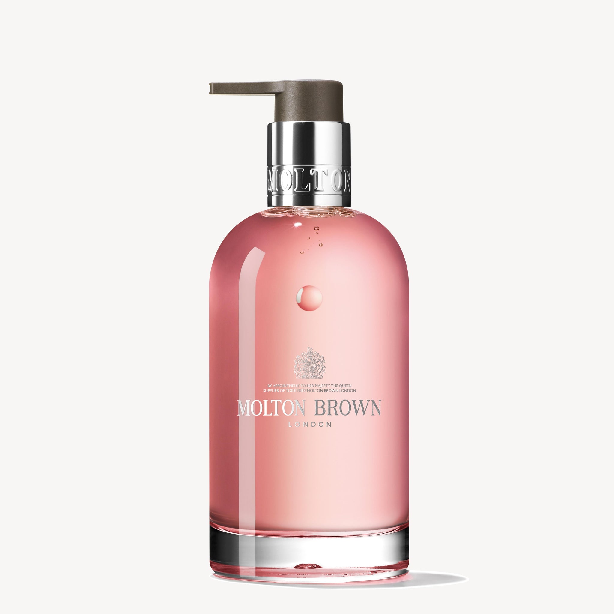 A 200ml glazen fles Delicious Rhubarb & Rose Vloeibare Handzeep van MoltonBrown Nederlands, met roze zeep en een zilveren pomp, ideaal voor reisformaten en gefotografeerd tegen een witte achtergrond.