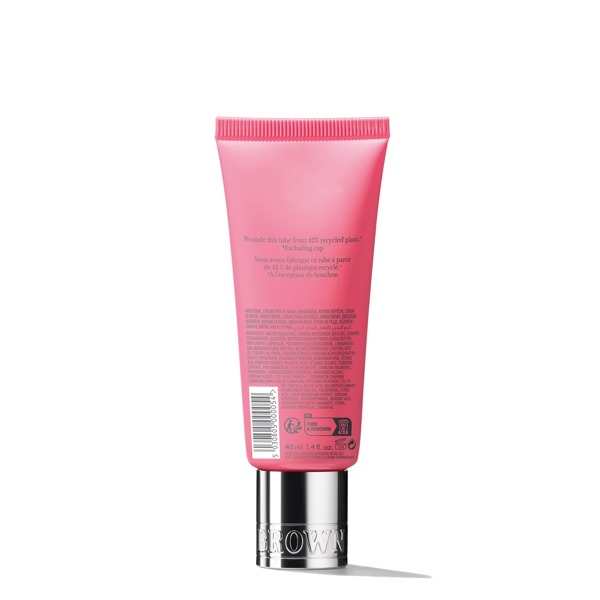 A 40ml tube of MoltonBrown Nederlands Fiery Pink Pepper Handcrème is shown from the back, displaying product details against a plain white background. The pink packaging features a silver cap.