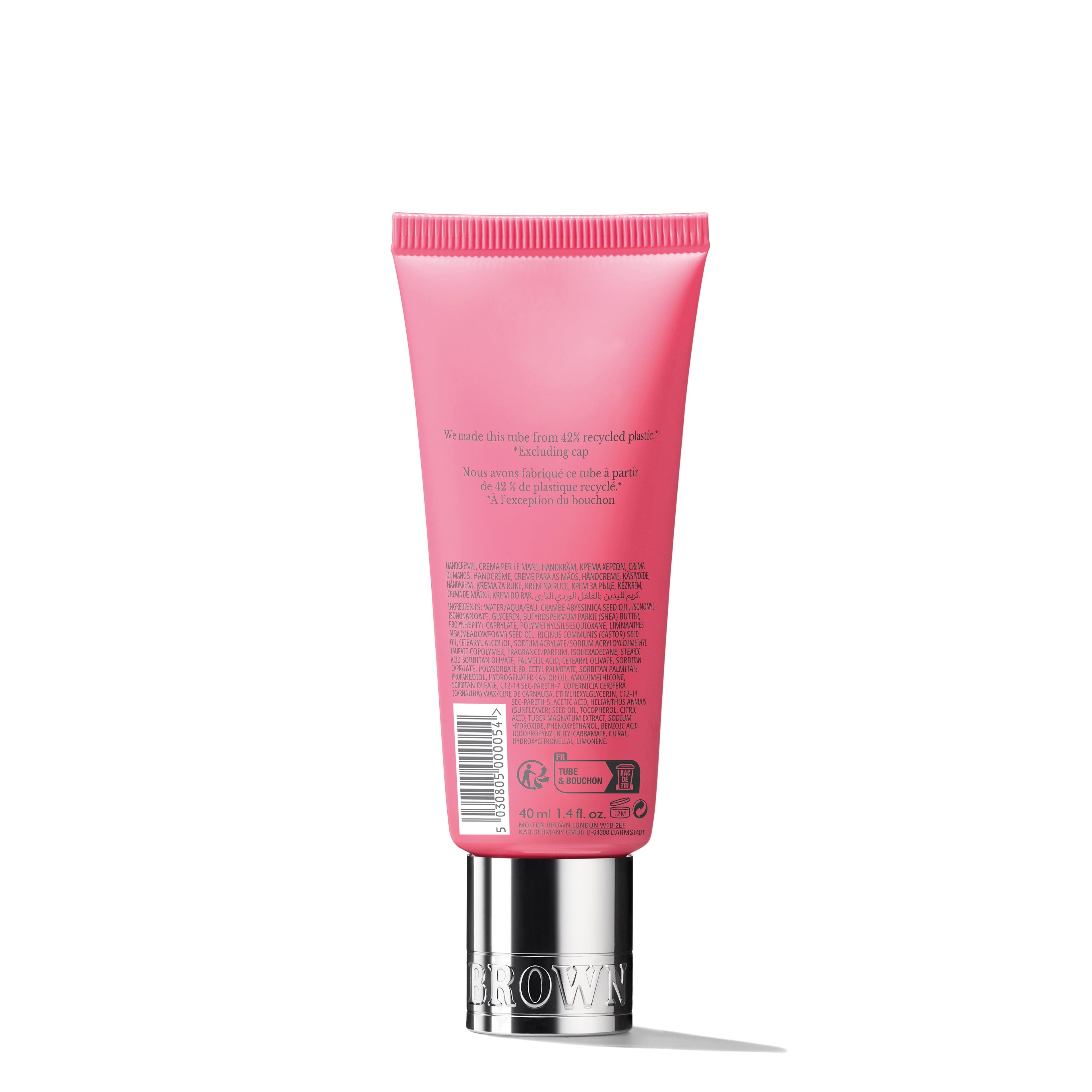 A 40ml tube of MoltonBrown Nederlands Fiery Pink Pepper Handcrème is shown from the back, displaying product details against a plain white background. The pink packaging features a silver cap.
