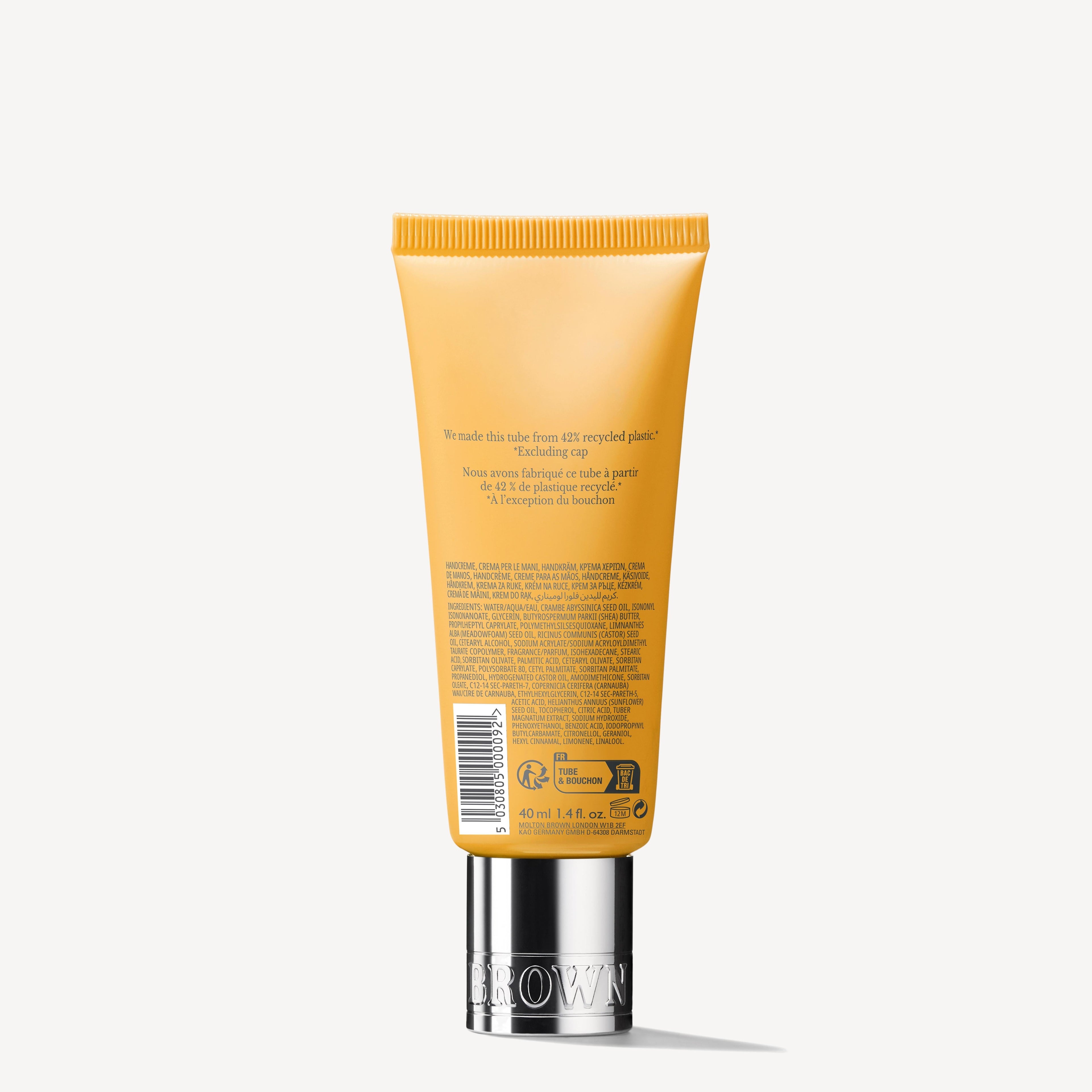 A 40ml yellow tube of MoltonBrown Nederlands Flora Luminare Handcrème with a silver cap stands upright, showing product details and text on the back, photographed against a plain white background.