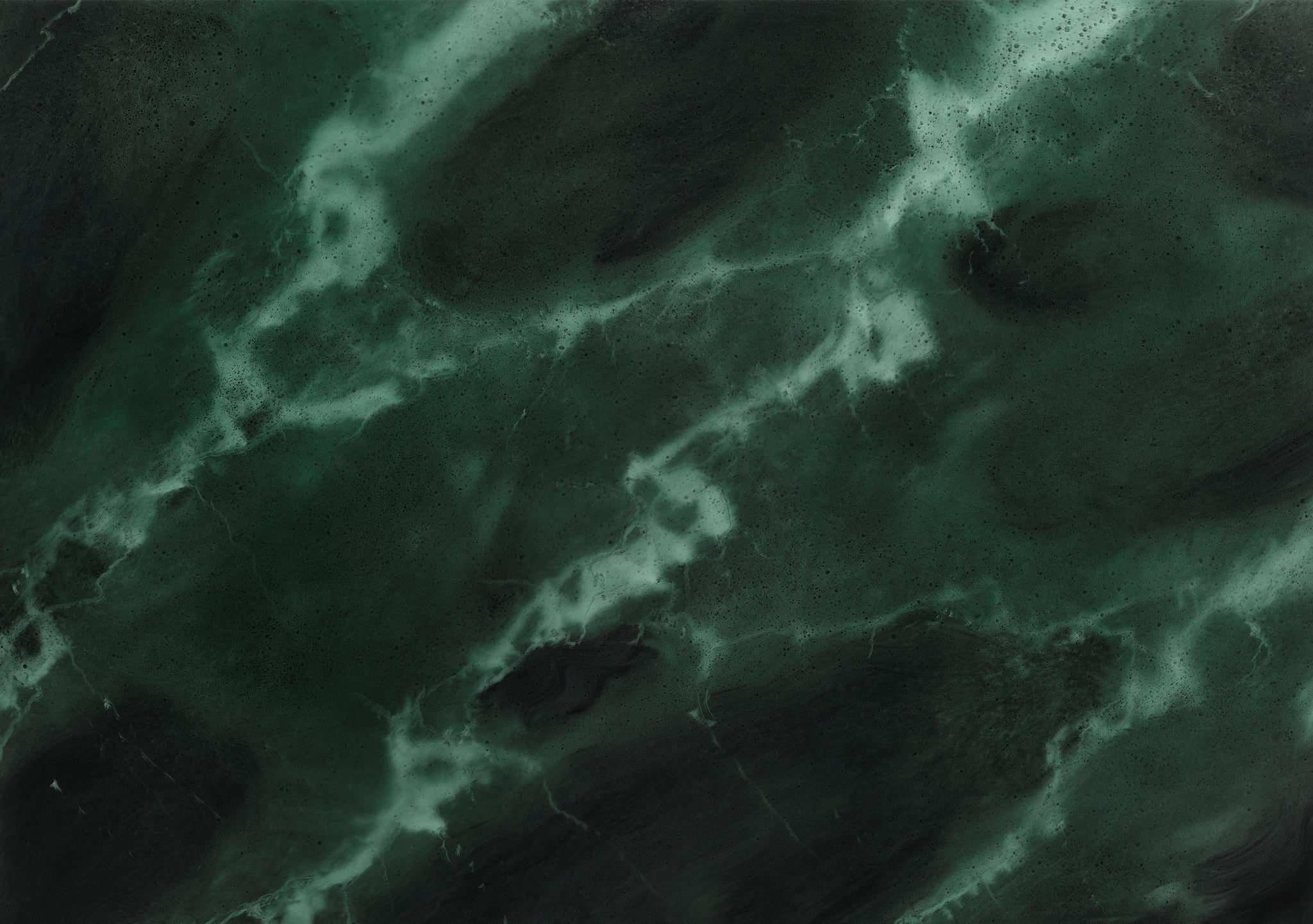 Dark green marble texture with swirling lighter green and white veins creating a natural, abstract pattern. The surface appears smooth and polished, highlighting the rich colors and organic lines.